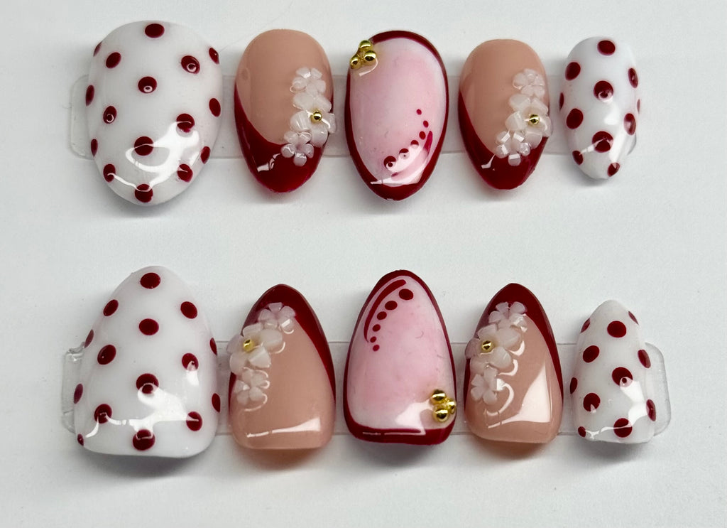 Set of nail art designs with polka dots and floral patterns on a white background