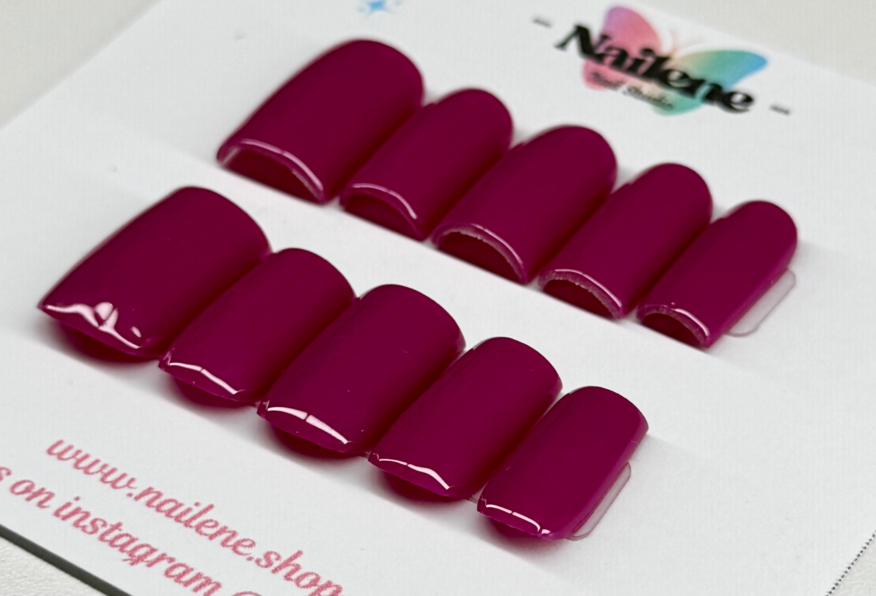 Set of purple plum nail polish samples on a white background with 'Nailene' branding.