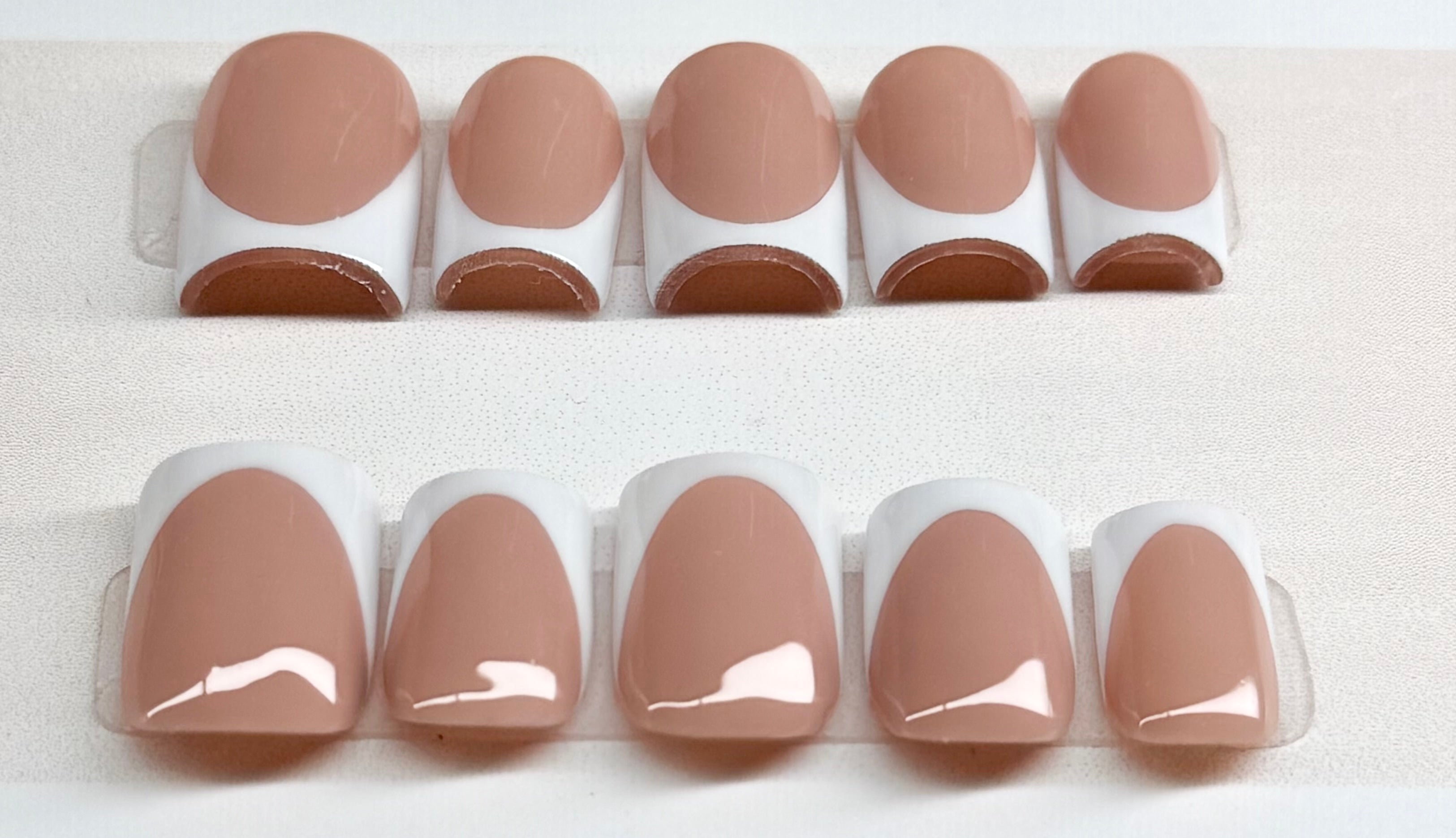 Set of nude base nail polish with white french tips 
