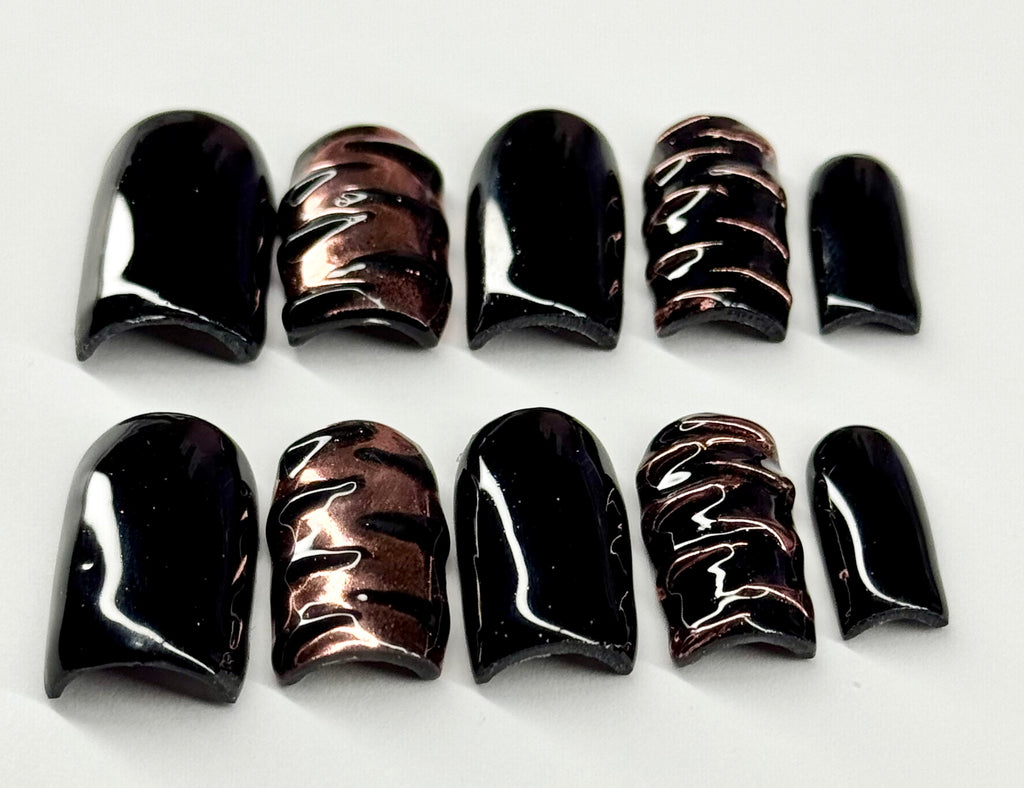 Set of black and brown nail polish samples on a white background