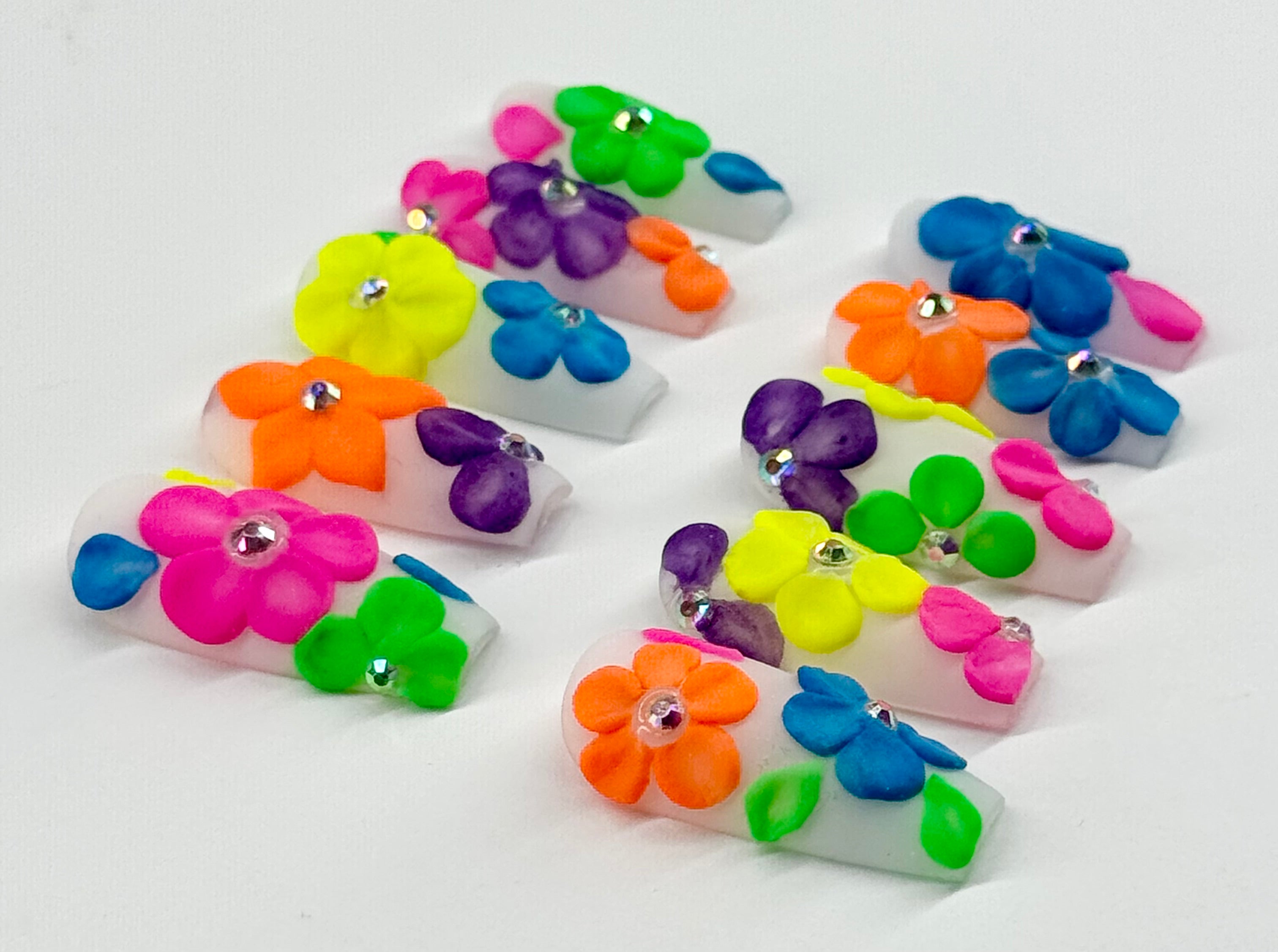 Colorful flower-shaped clips on a white background
