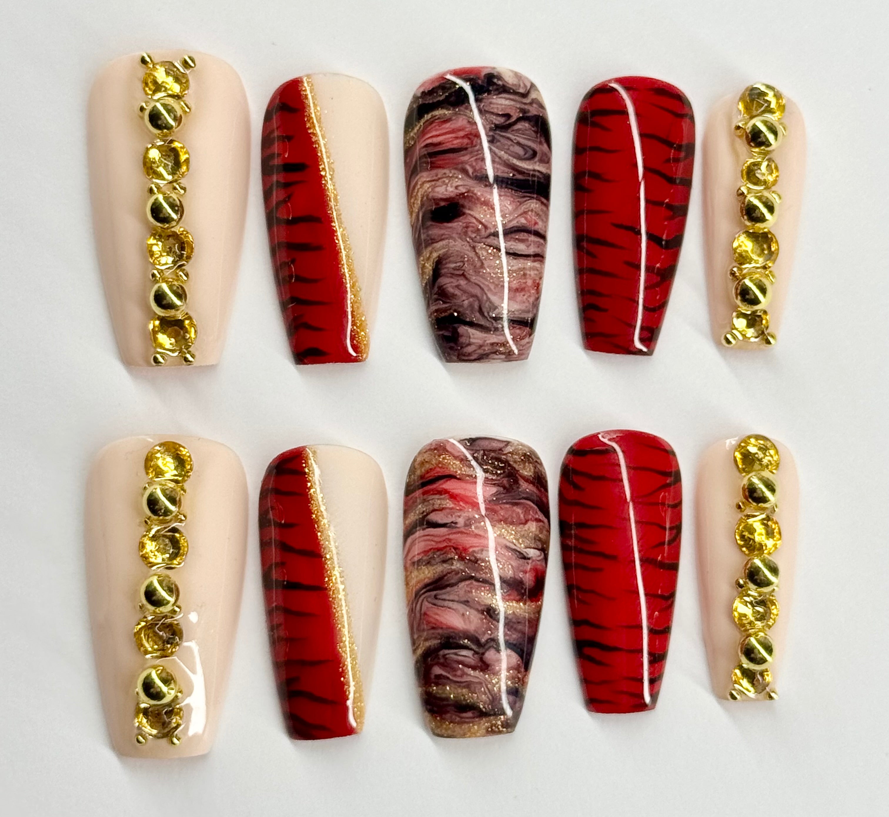 Set of nail art designs with gold accents on a white background