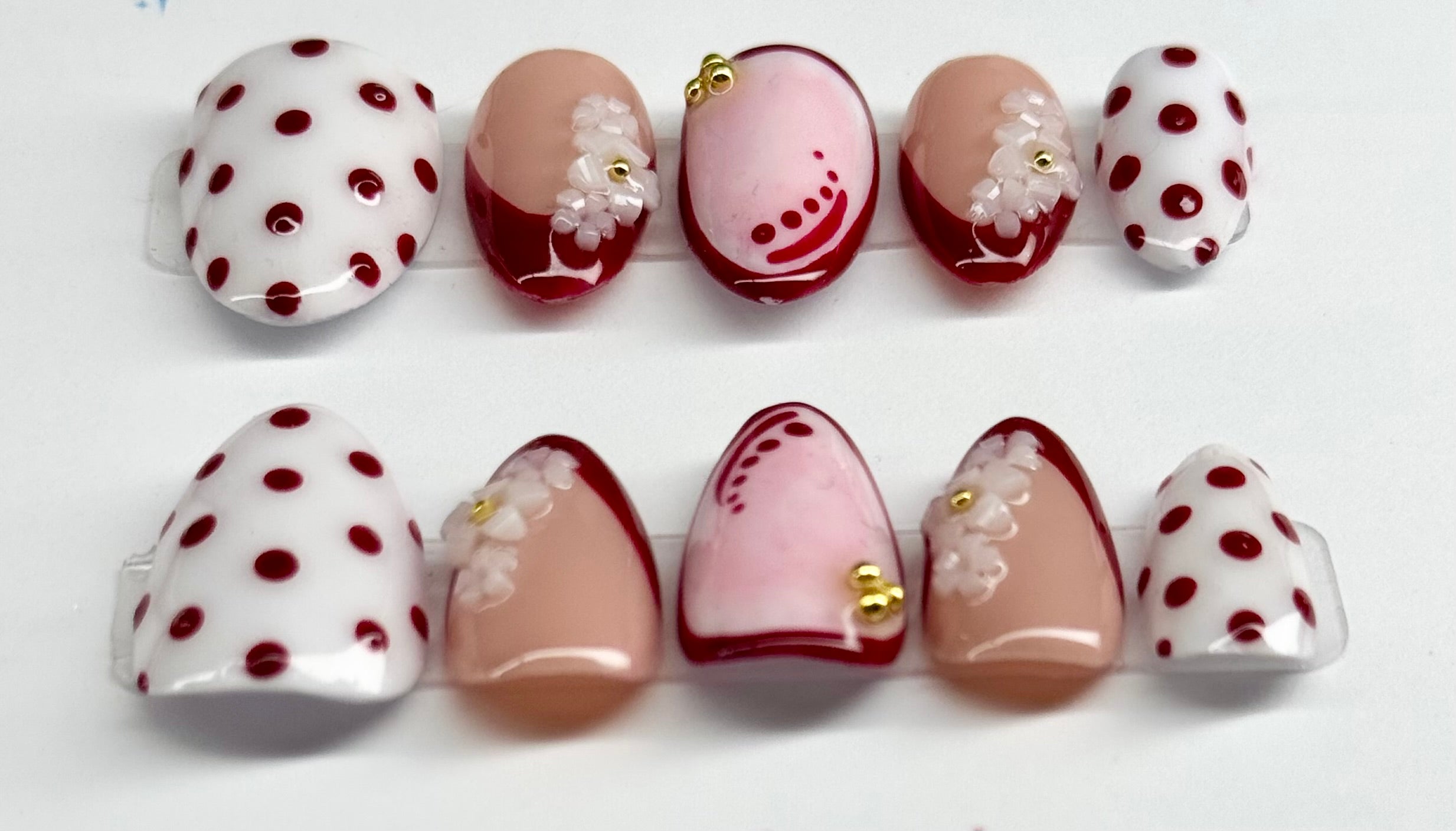 Set of nail art designs with polka dots and floral patterns on a white background