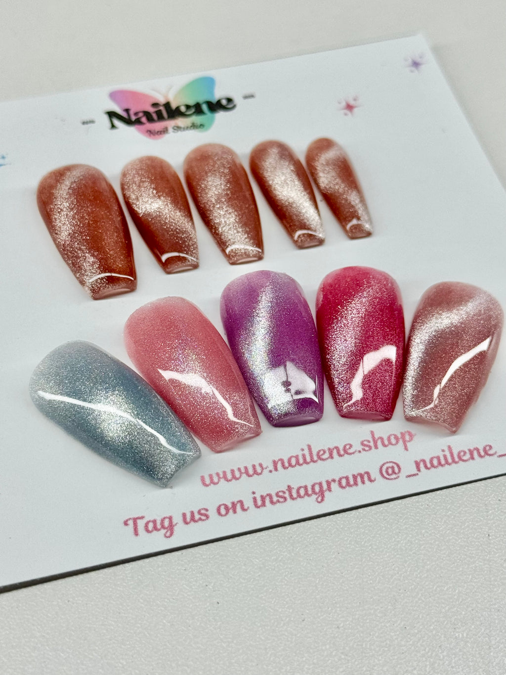 Set of glittery false nails on a Naikene branded card with website and Instagram handle.