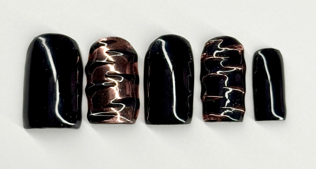 Set of five black and white marbled nail art designs on a white background