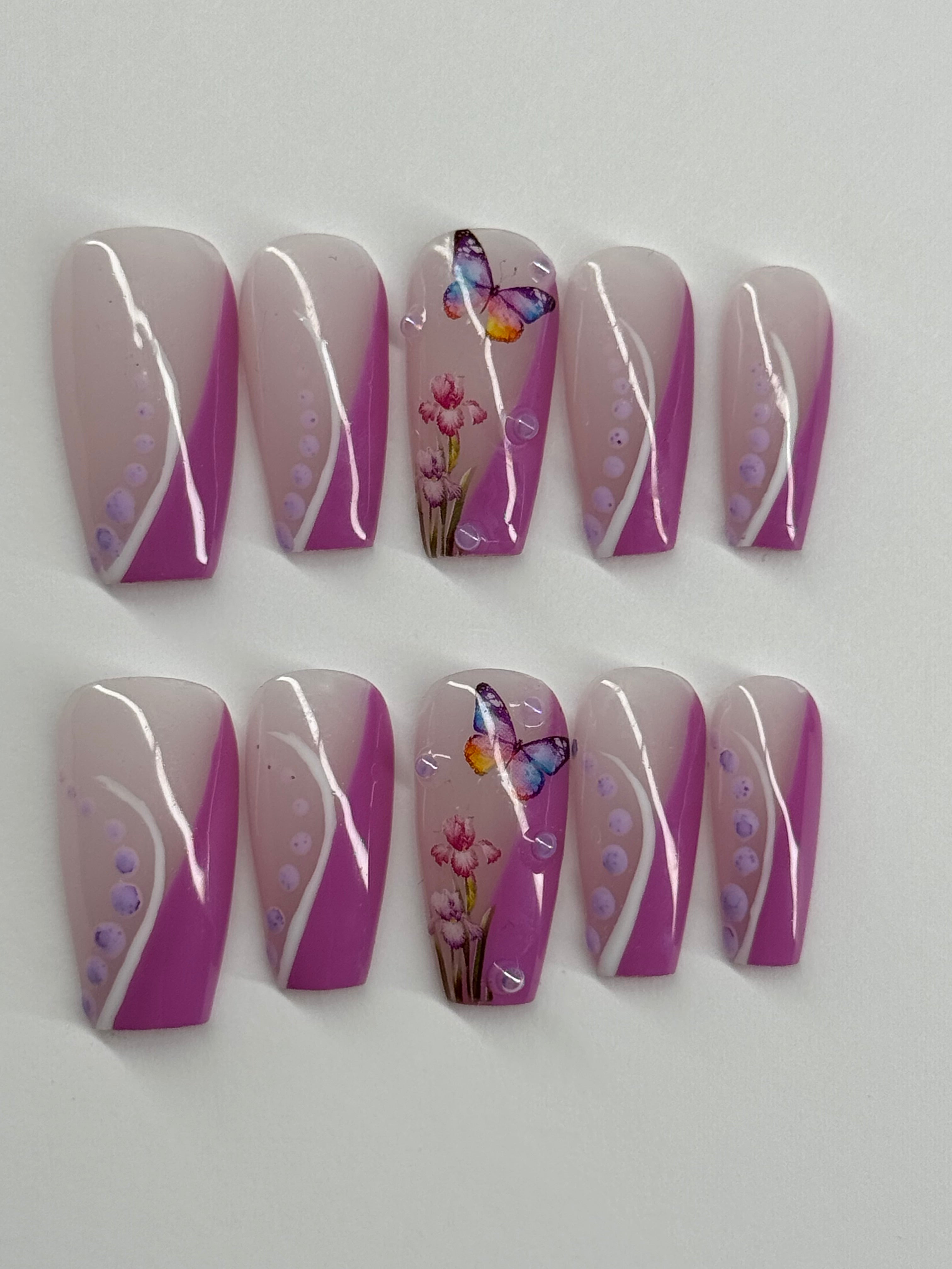 Set of purple and white nail art designs with butterflies and flowers on a white background