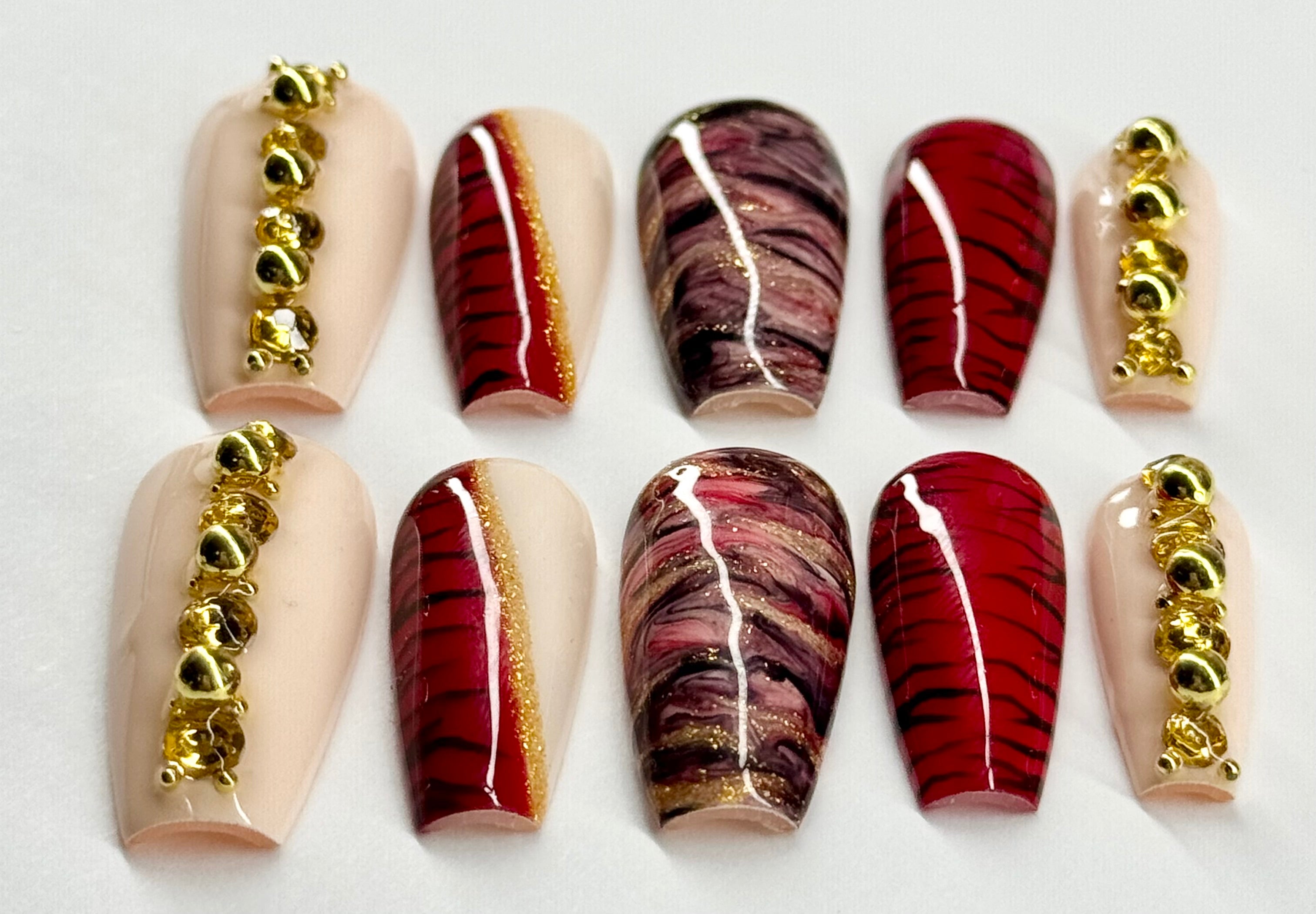 Set of nail art designs with gold accents on a white background