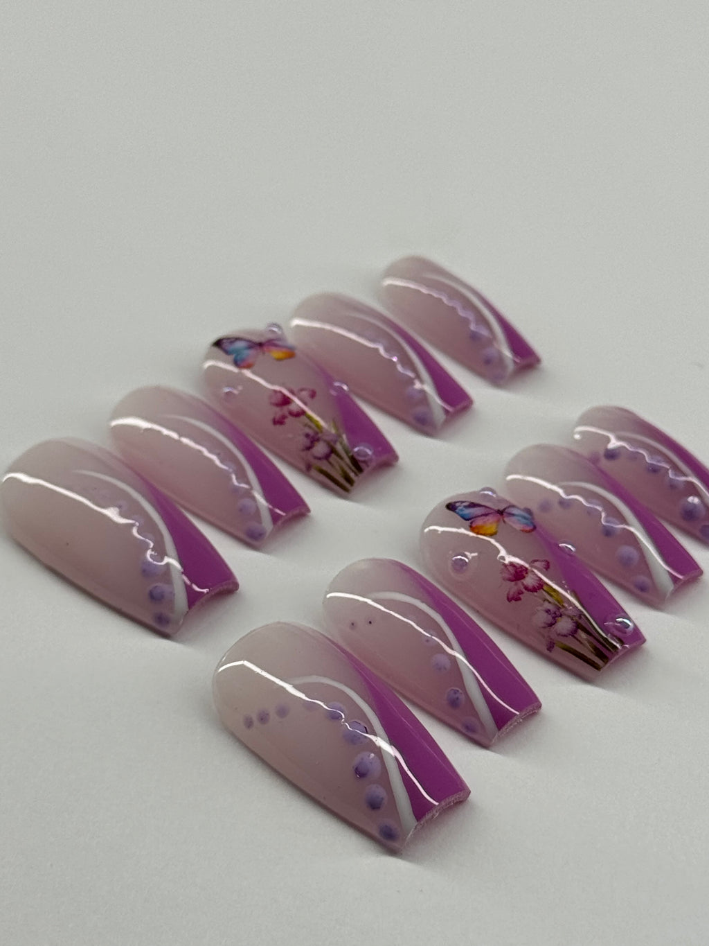 Set of purple and white nail art designs on a light gray background