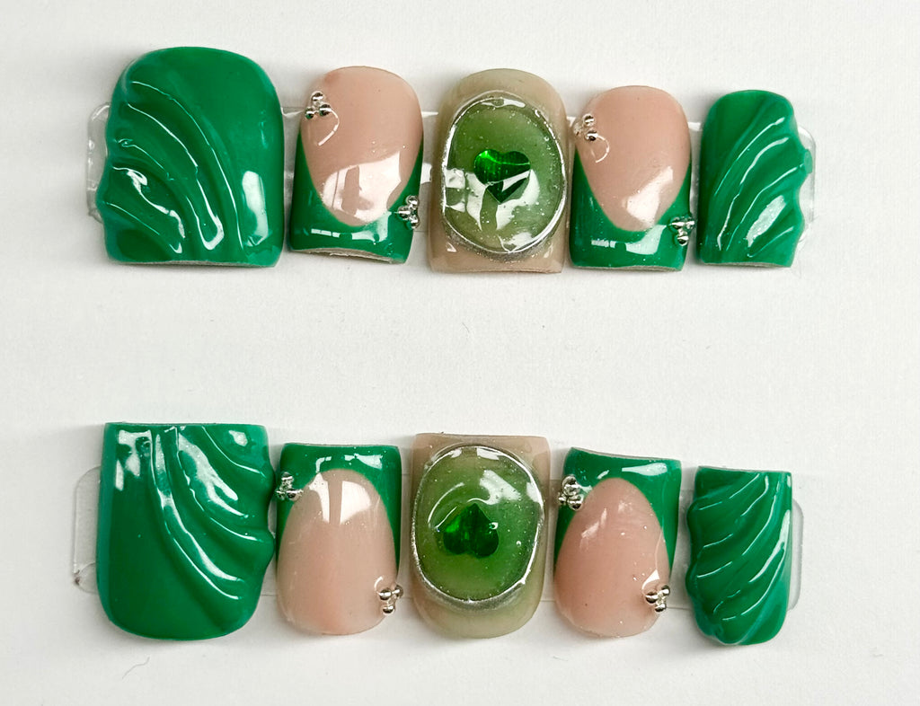 Set of green and beige nail art designs on a white background