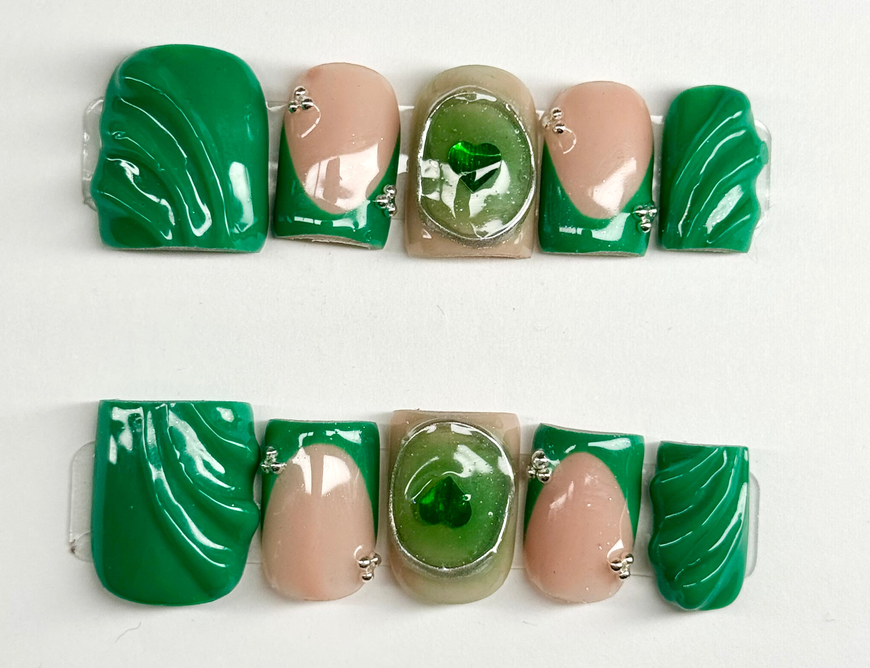 Set of green and beige nail art designs on a white background