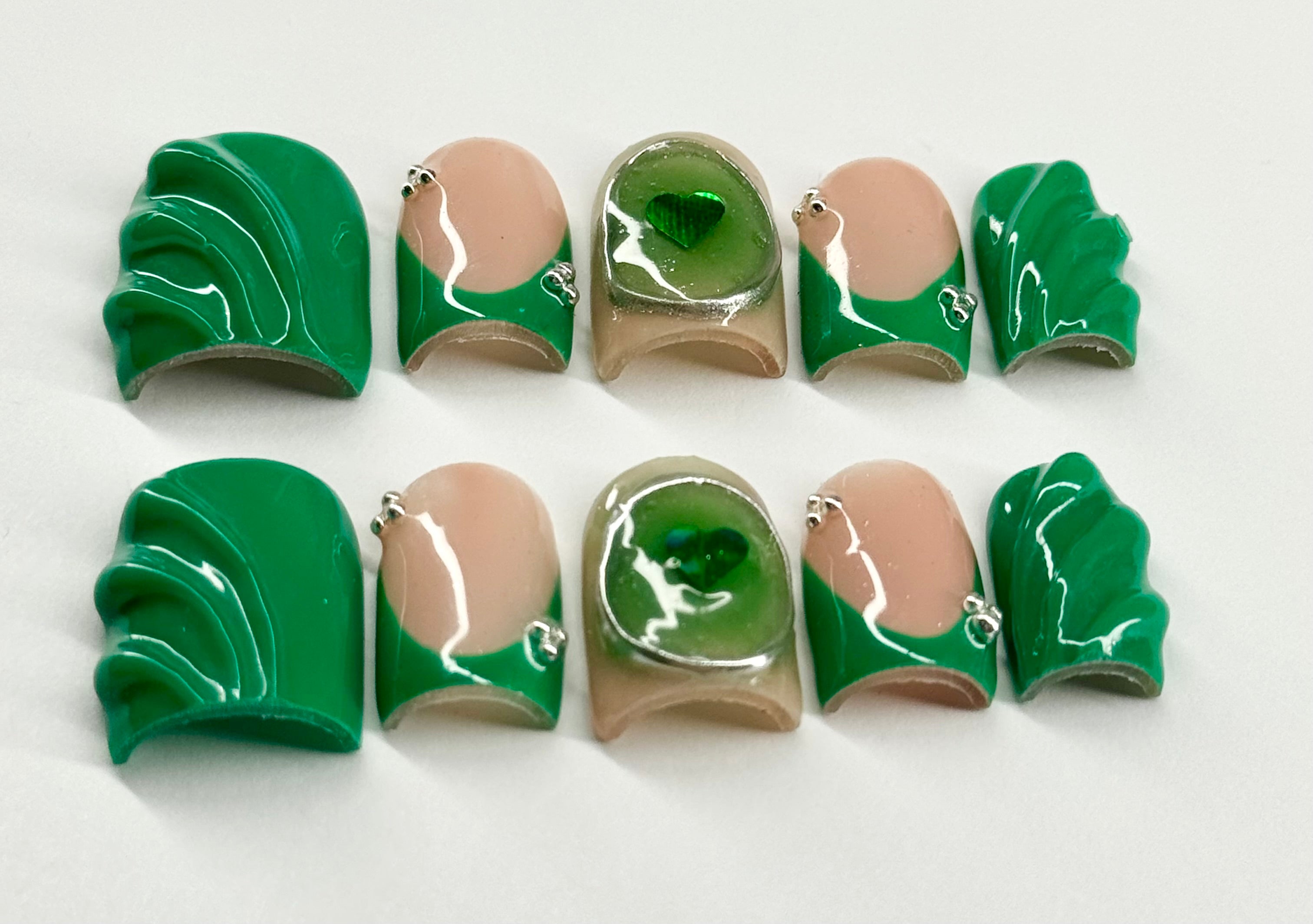 Set of green and beige nail art designs on a white background