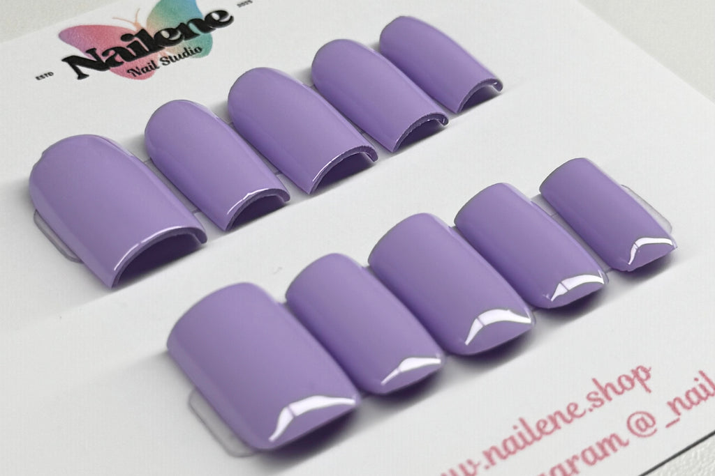 Set of purple nail tips on a white background with 'Nailene' branding.