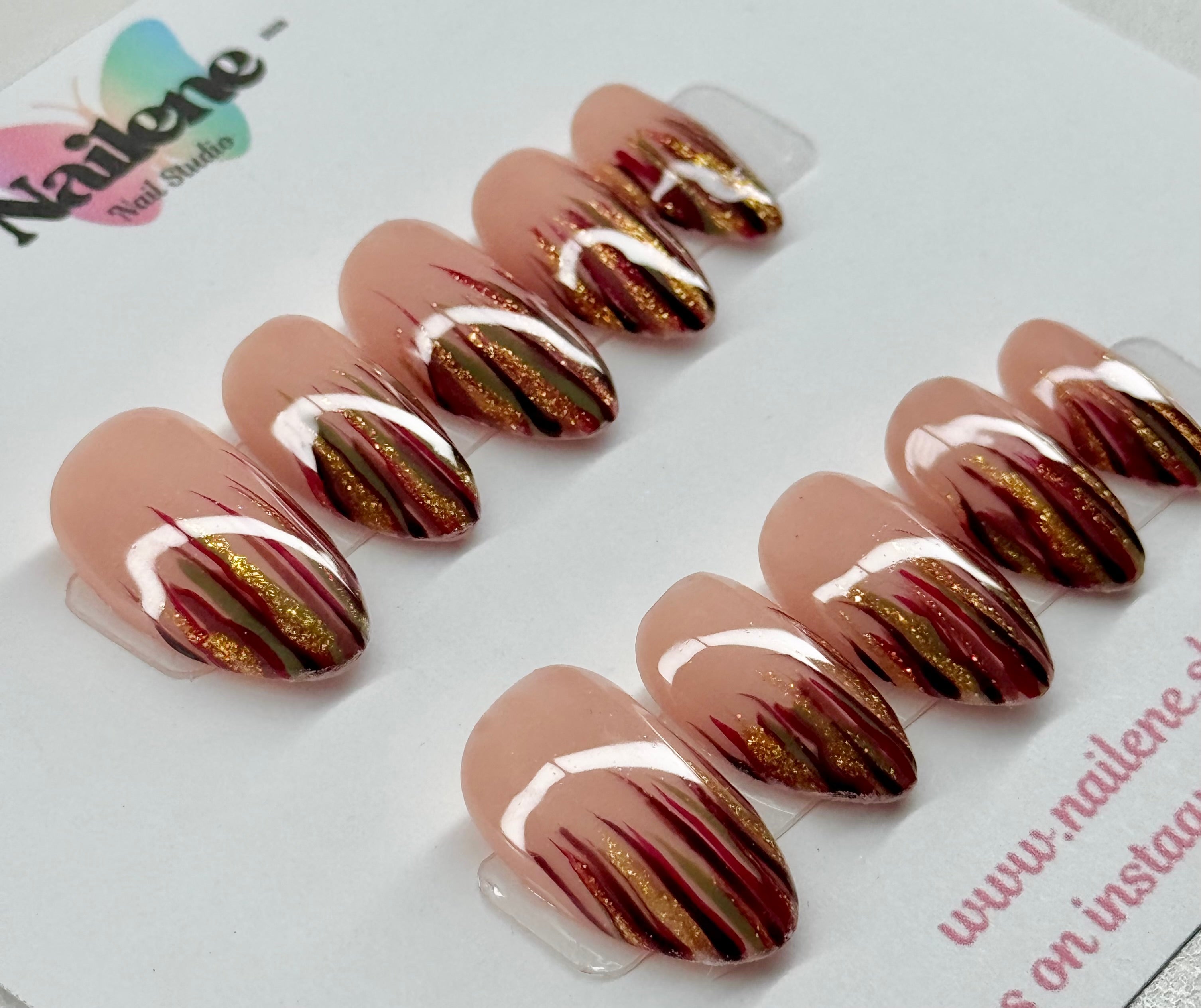Set of nail art designs with gold and red accents on a white background, featuring the brand 'Nailene'.
