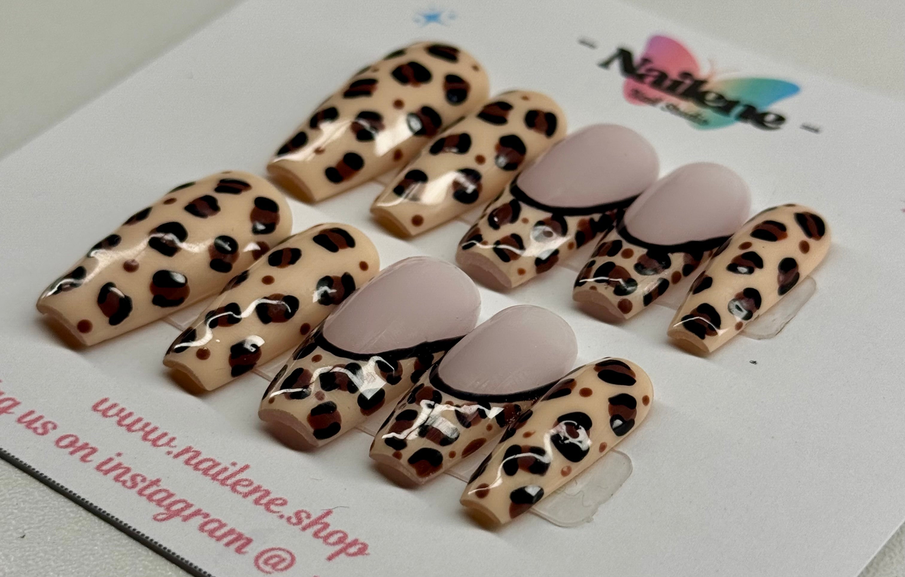 Leopard print nail art designs on clear sheets with a visible brand logo.