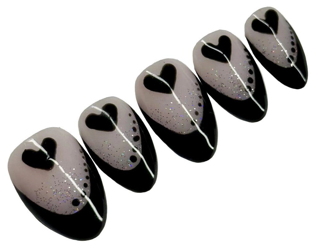 Black, white, and gray decorative items with heart shapes on a light gray background