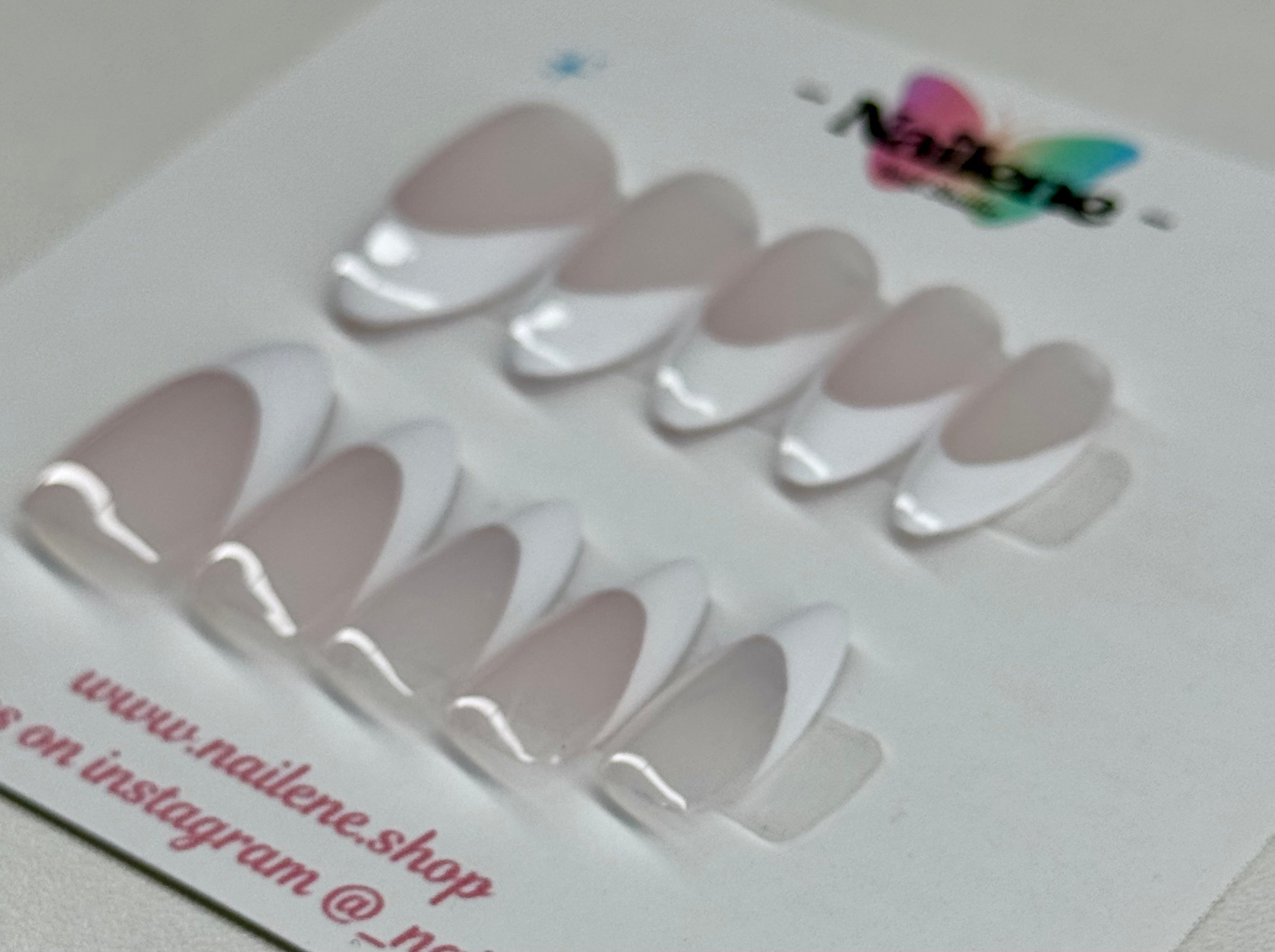 Set of false nails on a display card with Nailene branding.
