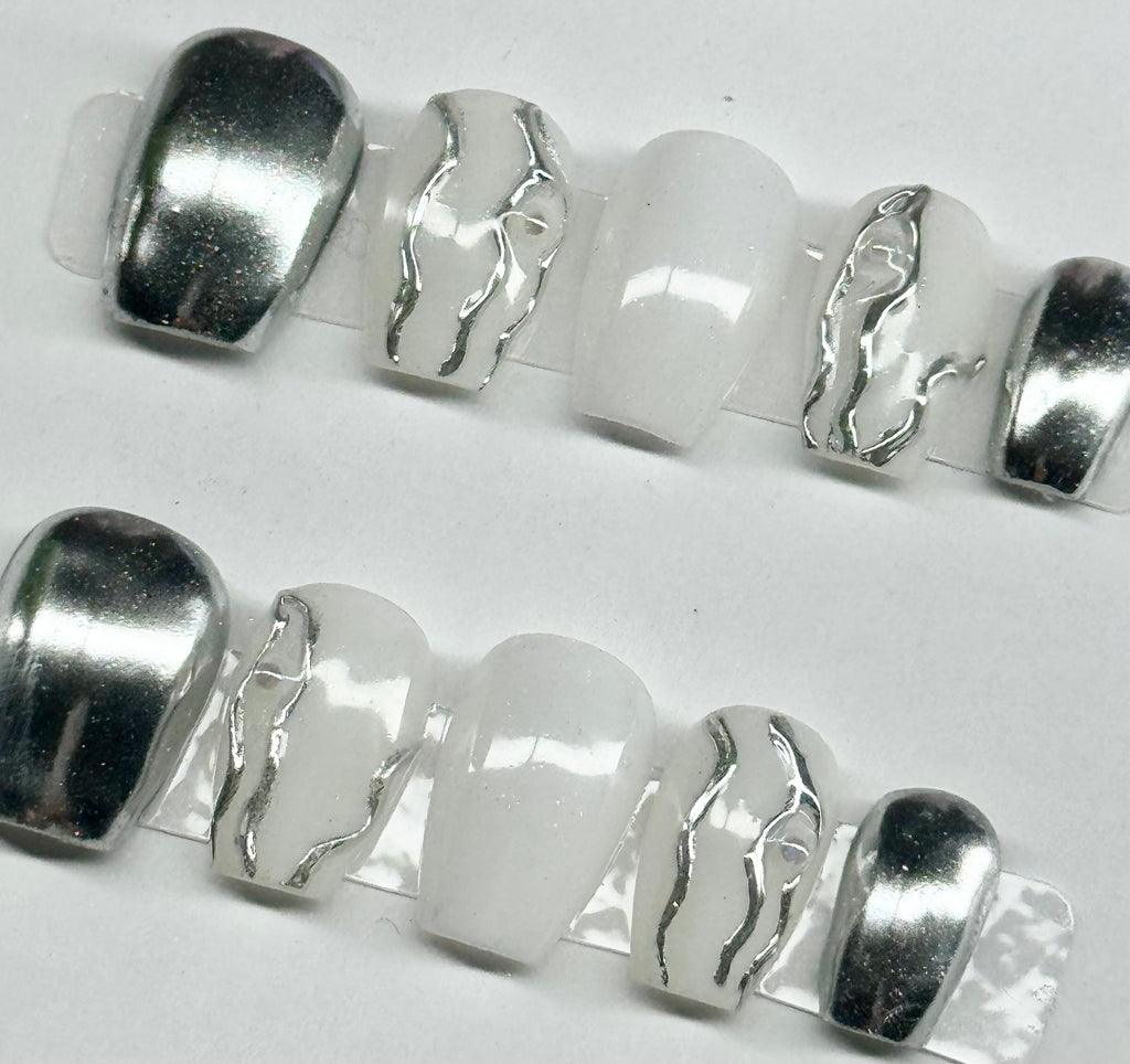 Silver and white beads on a white background