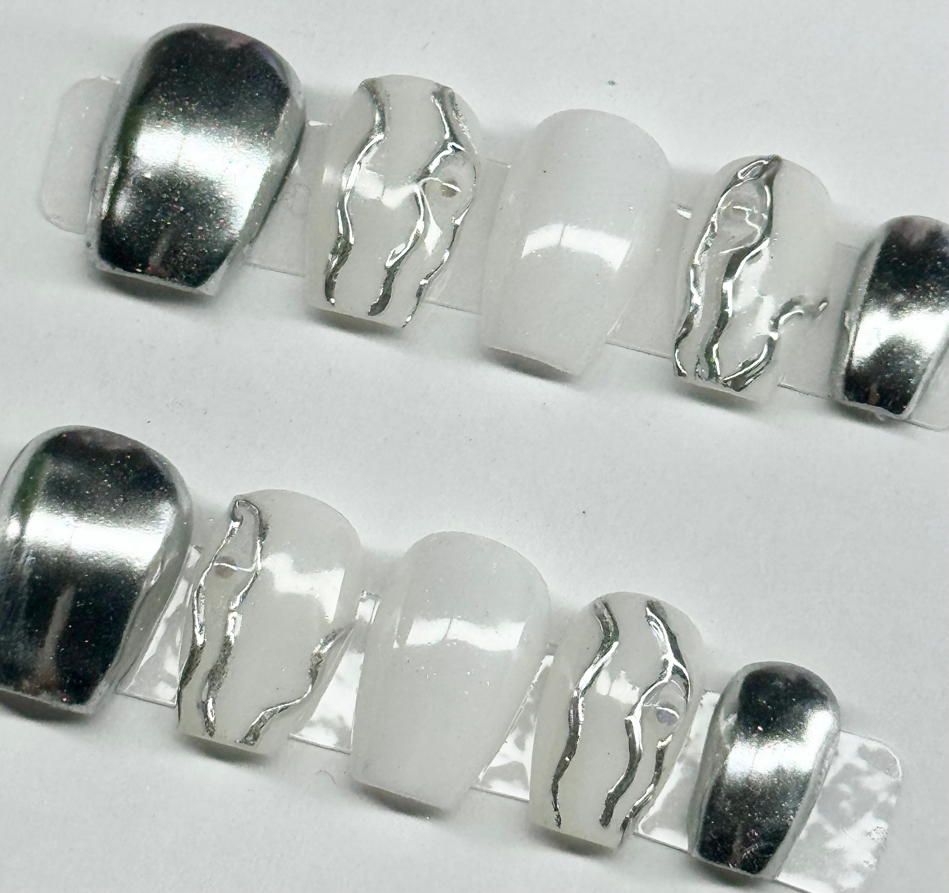 Silver and white beads on a white background