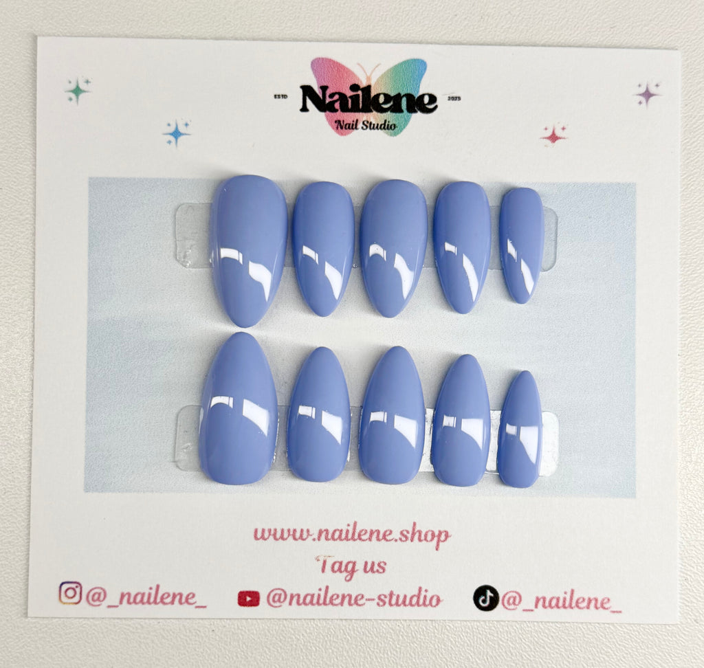 Set of blue nail tips on a branded card with Nailene Studio logo.