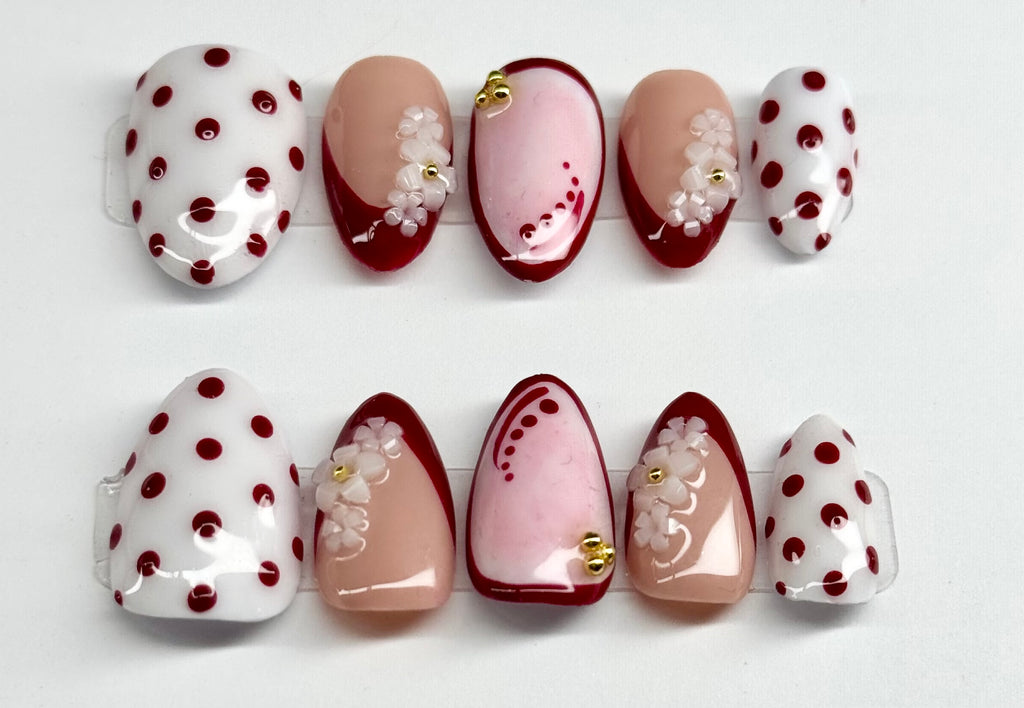 Set of nail art designs with polka dots and floral patterns on a white background