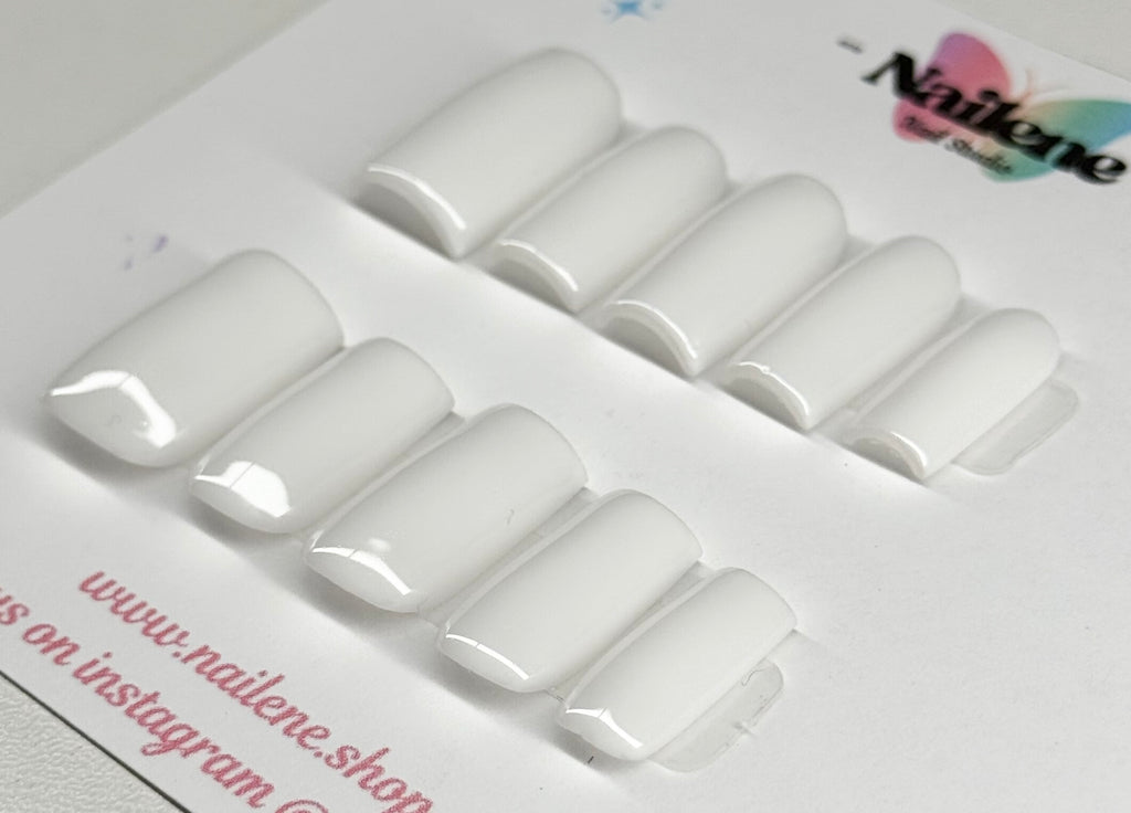 Set of white nail extensions on a branded tray with 'Nailene' branding.