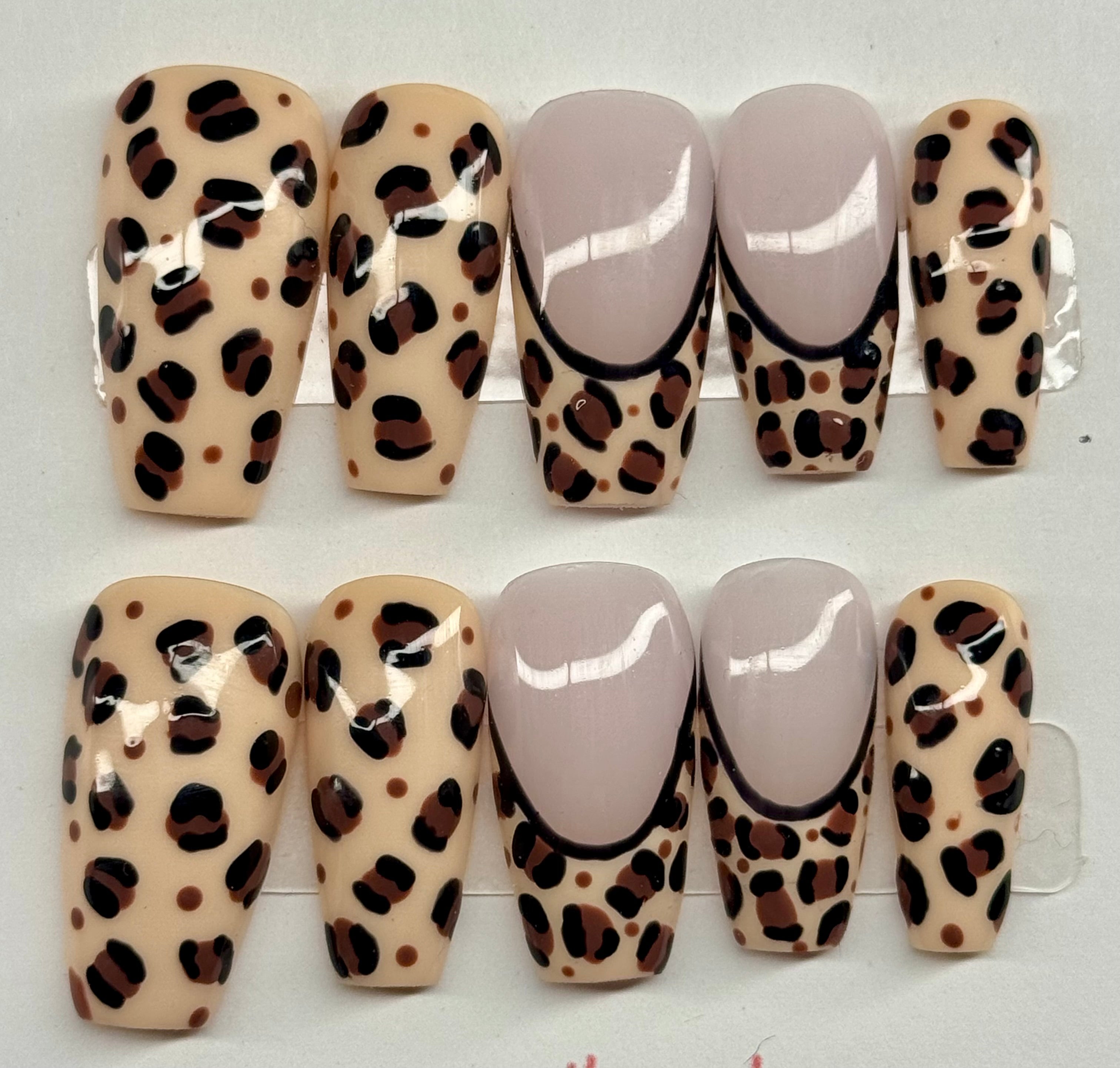 Set of leopard print nail designs on beige background