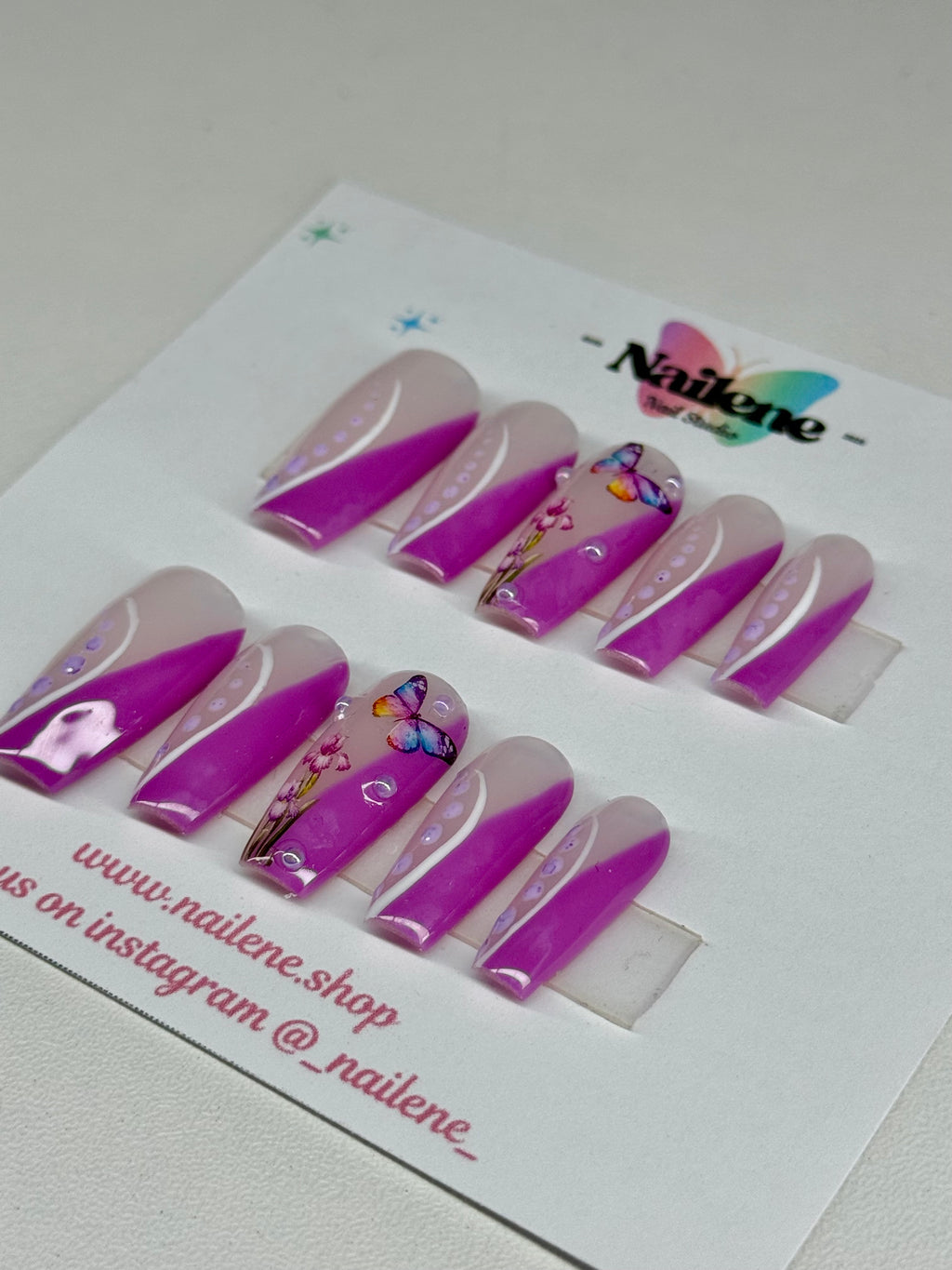Set of purple and white nail art designs on a white card with Nailene branding.