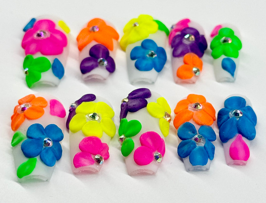 Colorful flower-shaped nail art decorations on a white background