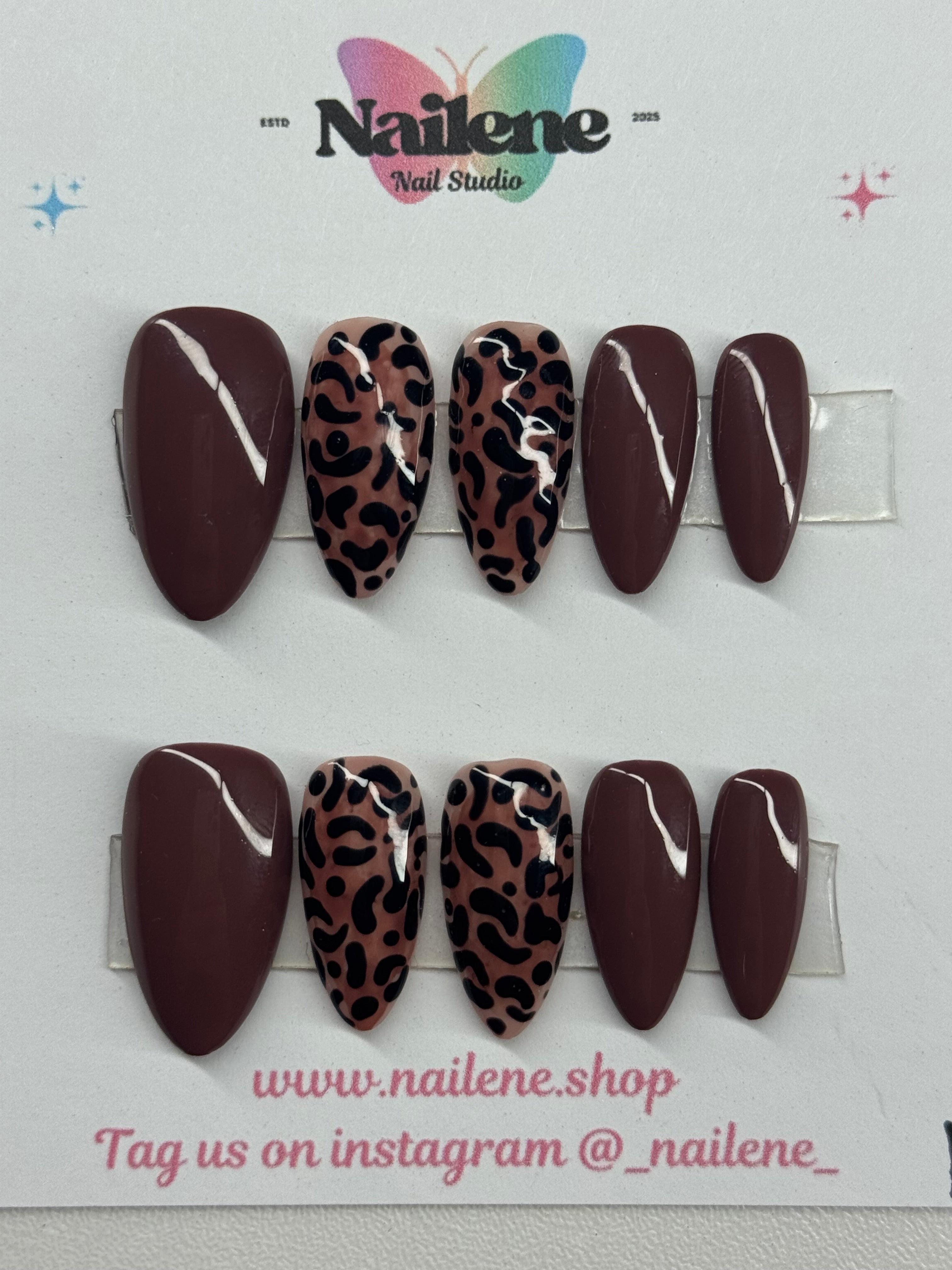 Set of leopard print nail art designs on a white card with Nailene branding.