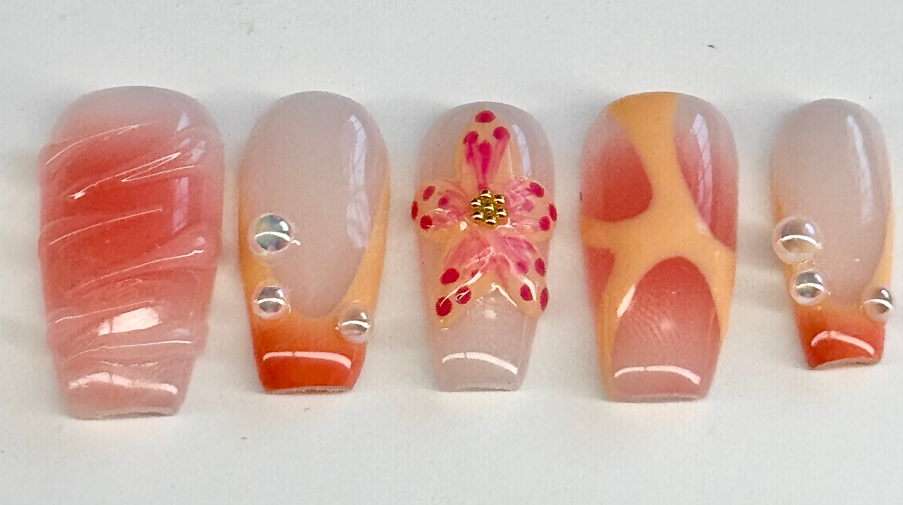 Set of five nail designs with different patterns on a white background