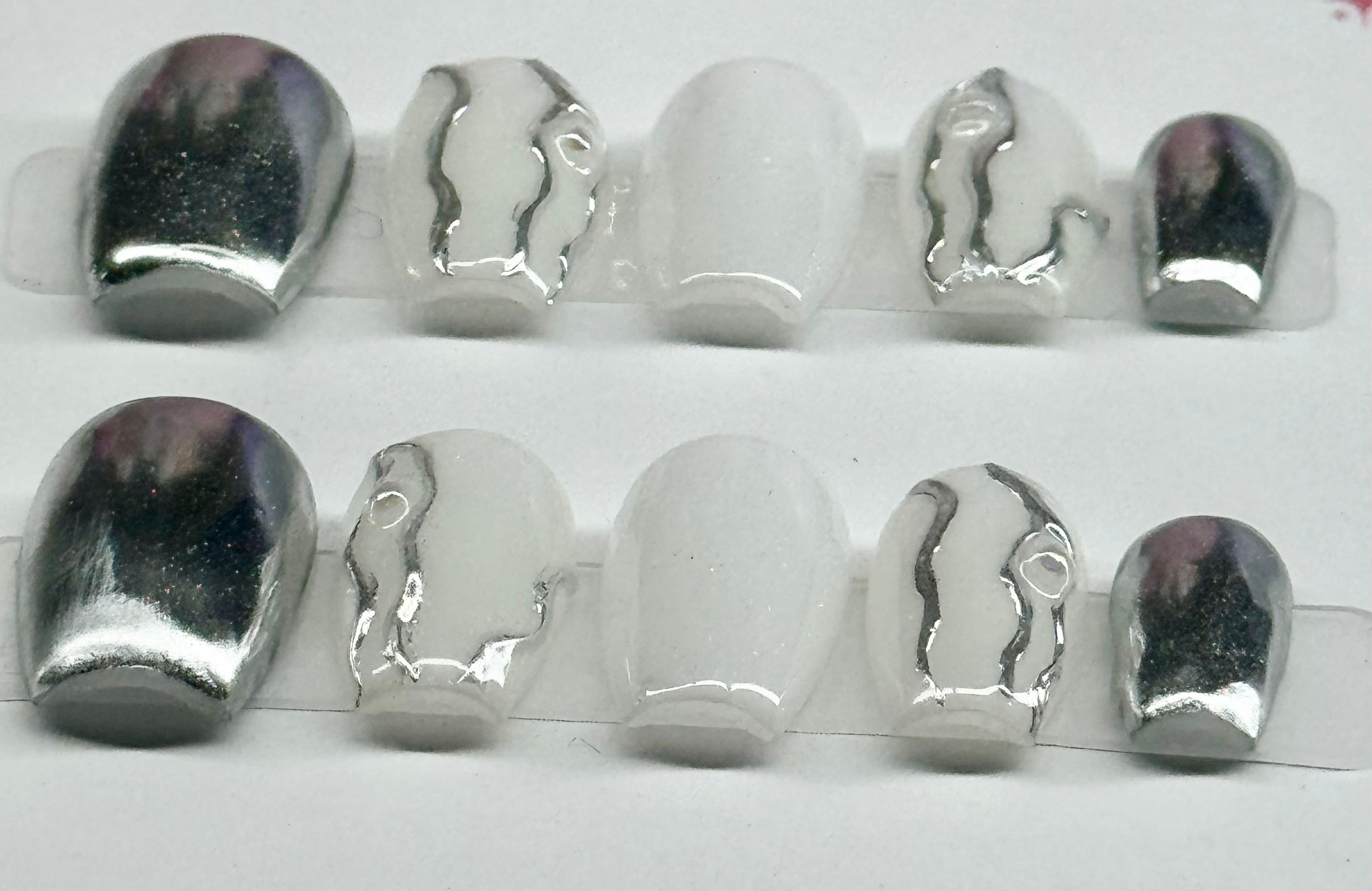 Set of metallic nail art tips on a white background