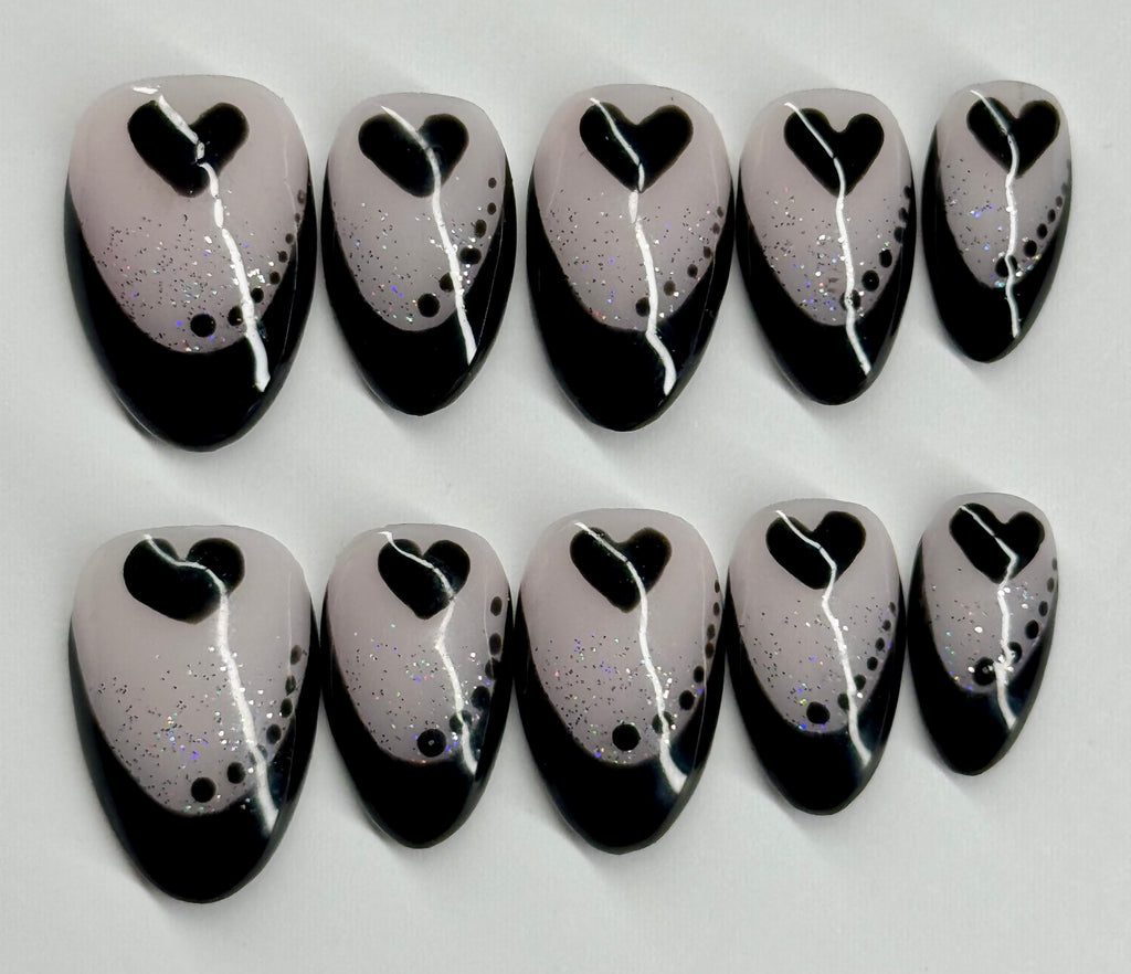 Set of black and white nail art designs on a light gray background