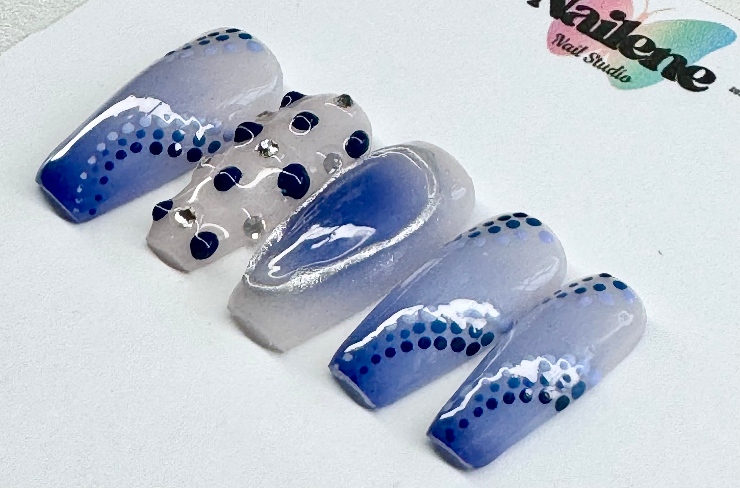 Set of blue and silver nail art designs on a white background with 'Nailene' branding.