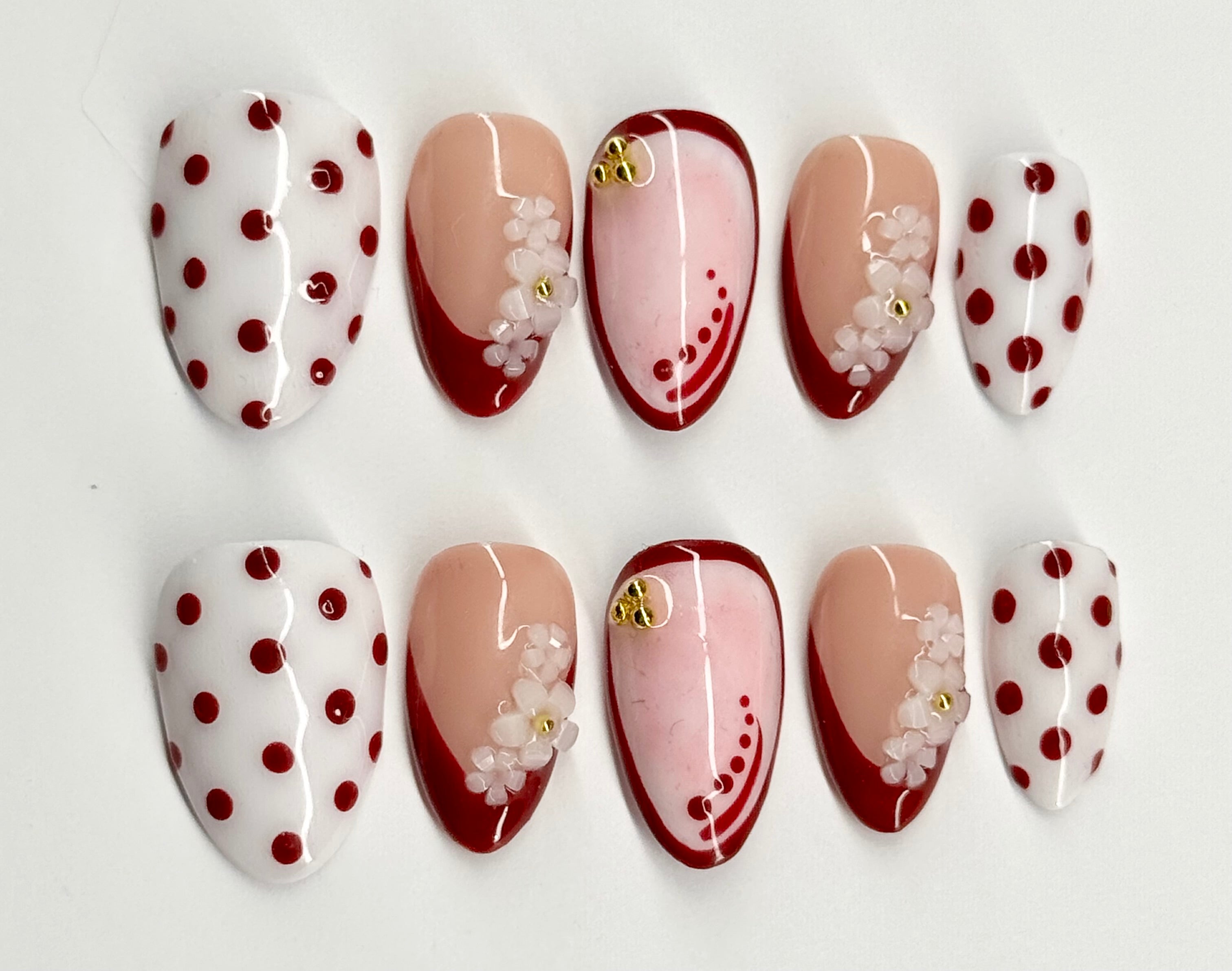 Set of nail designs with polka dots and floral patterns on a white background