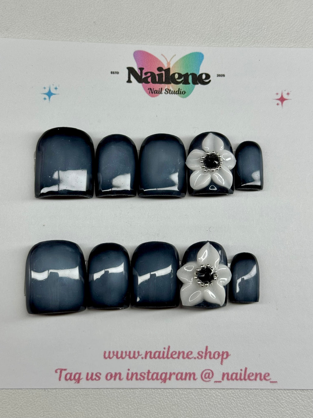 Black and white floral nail art design on a white background with Nailene branding.