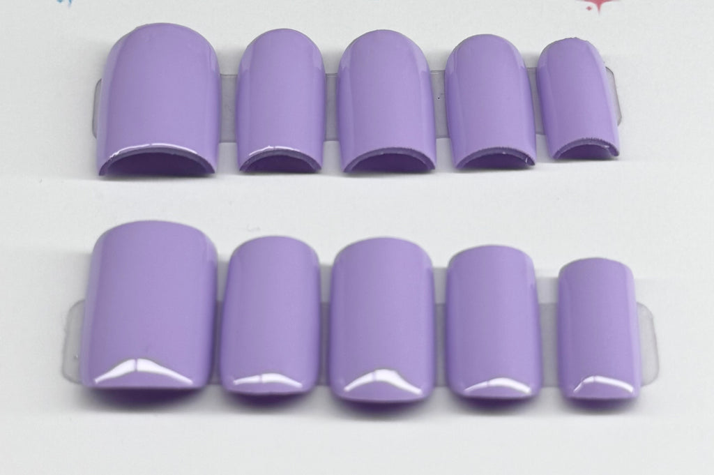 Set of purple nail tips on a white background