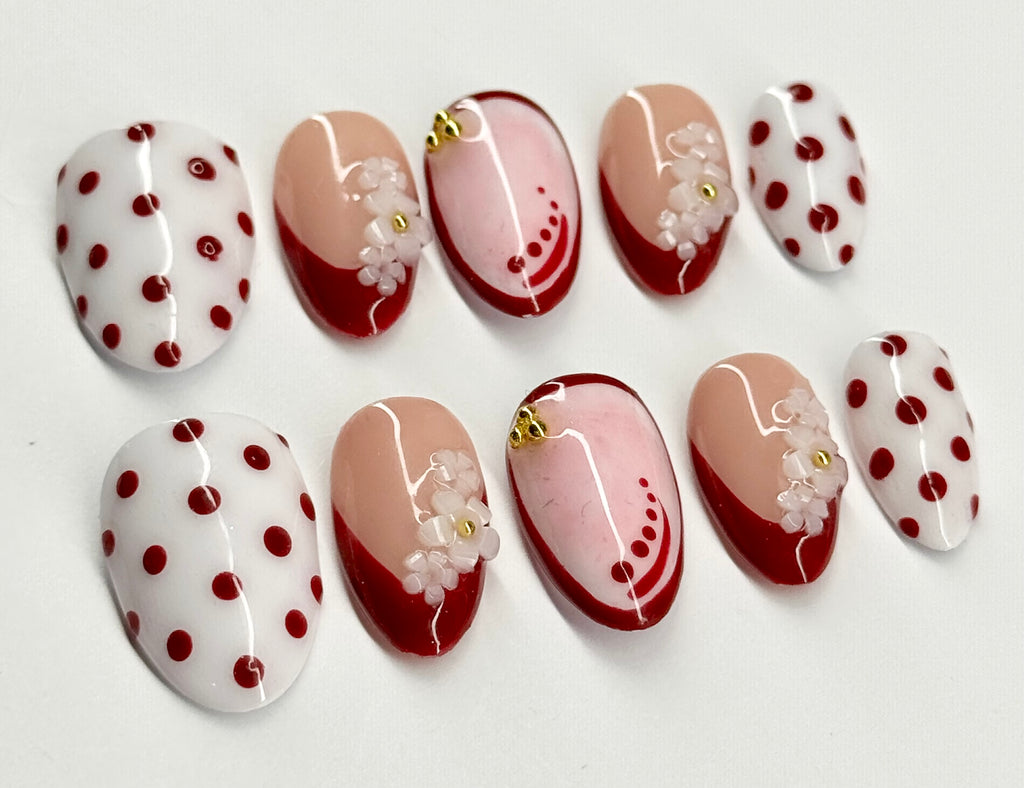 Set of nail art designs with polka dots and floral patterns on a white background