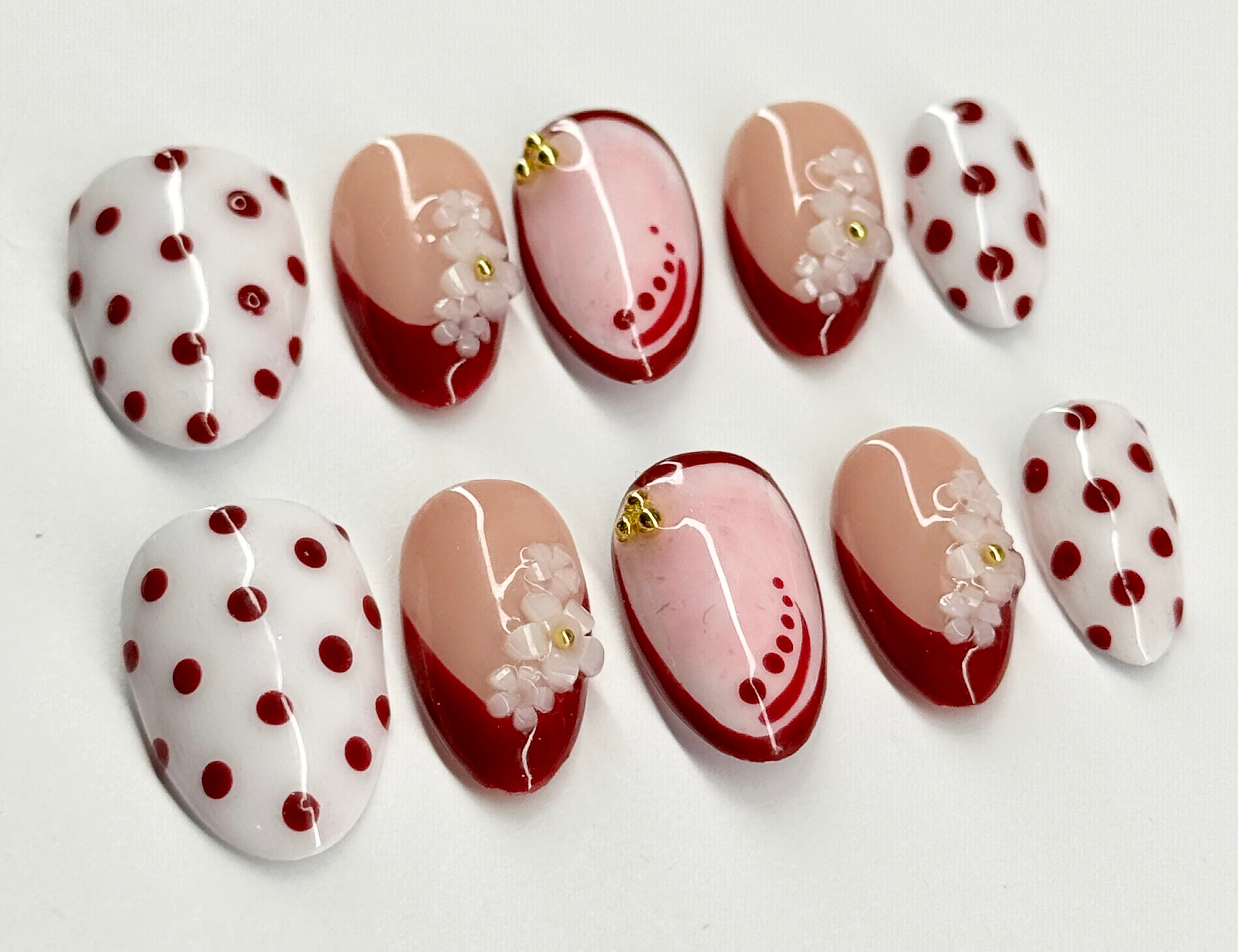 Set of nail art designs with polka dots and floral patterns on a white background