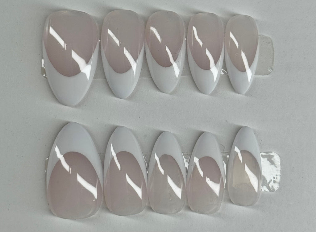 Set of clear nail extensions on a gray background