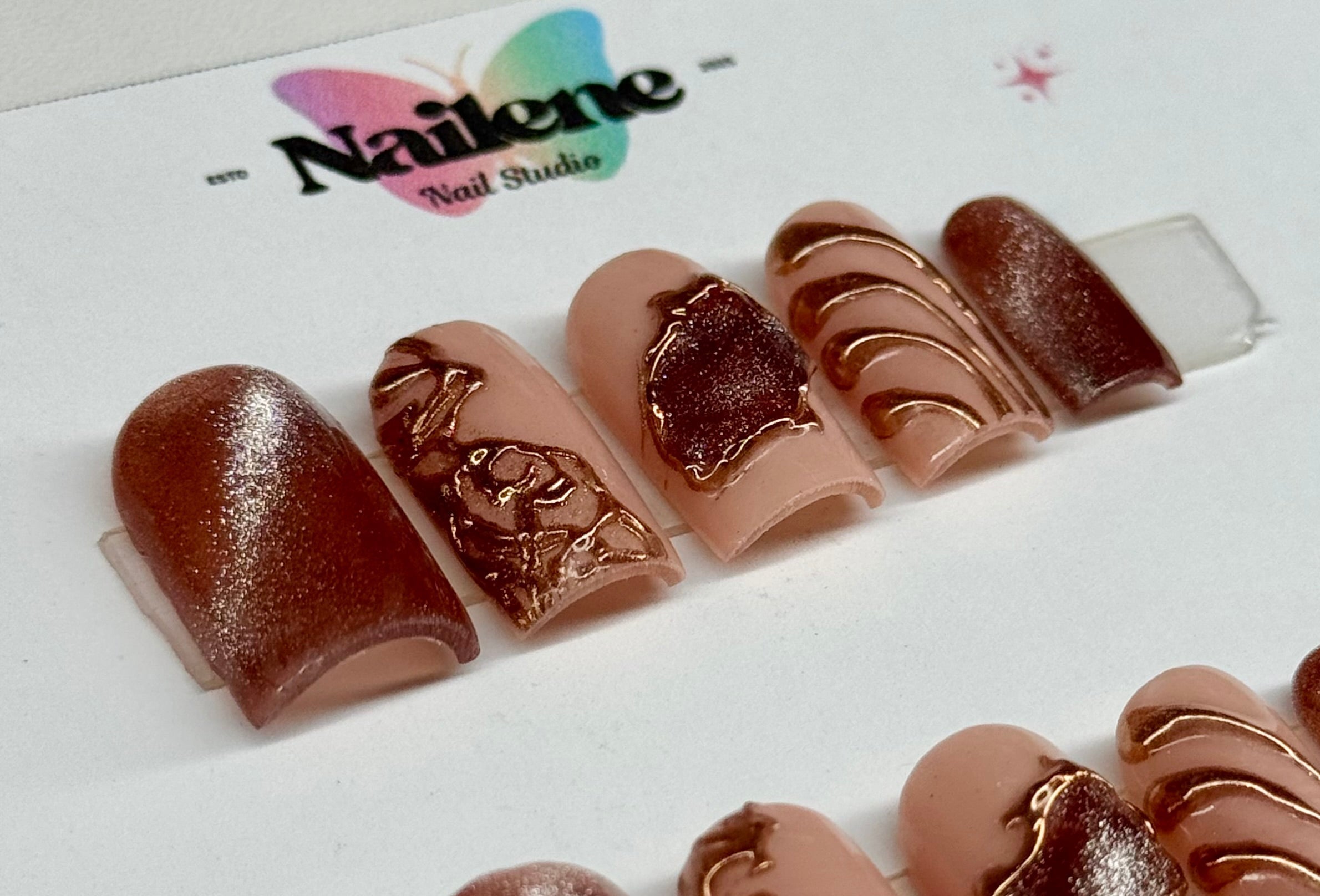 Set of decorative nail art samples on a white background with 'Nailene' branding.