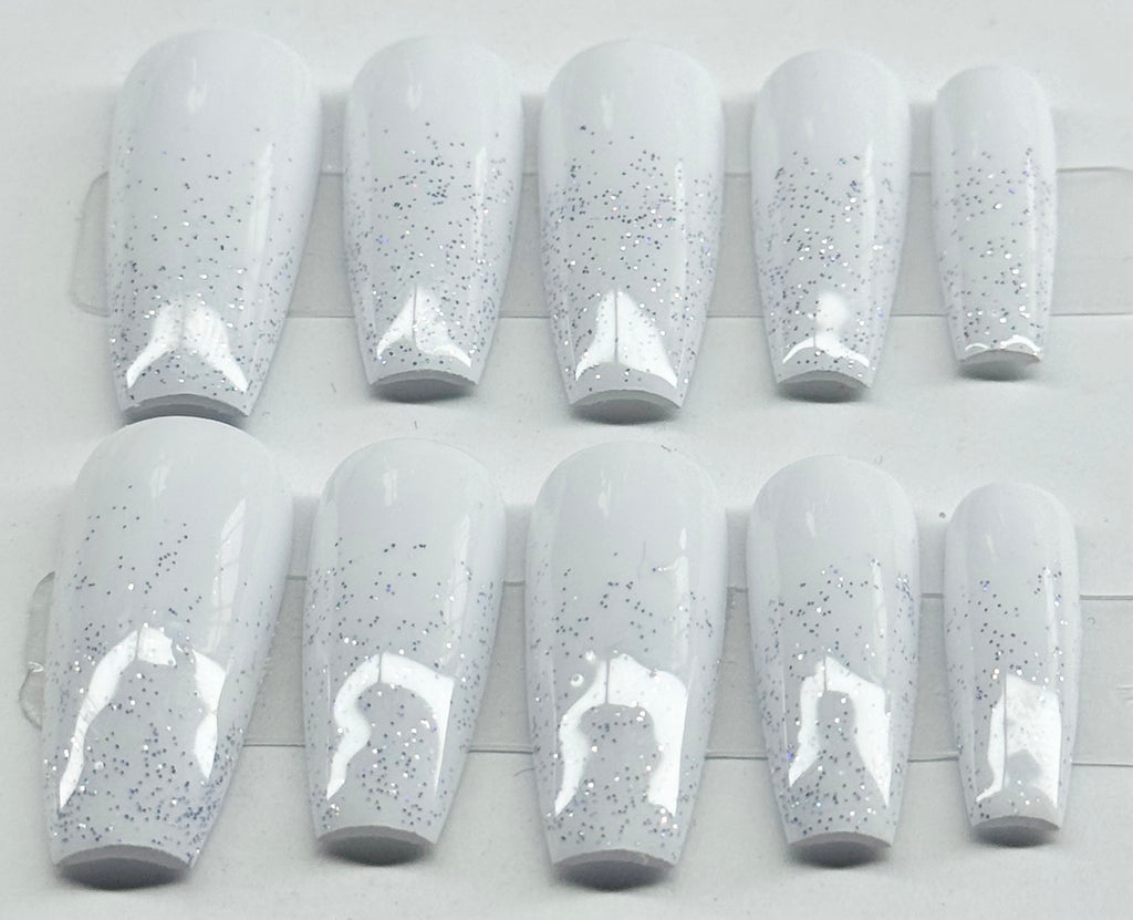Set of white nail polish with glittery specks on a white background