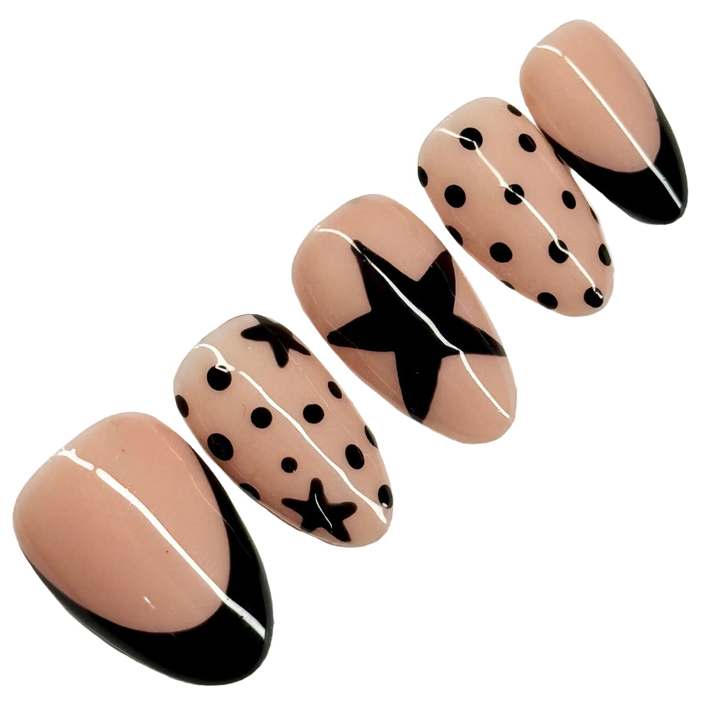 Nail art design with beige, black, and white on a white background