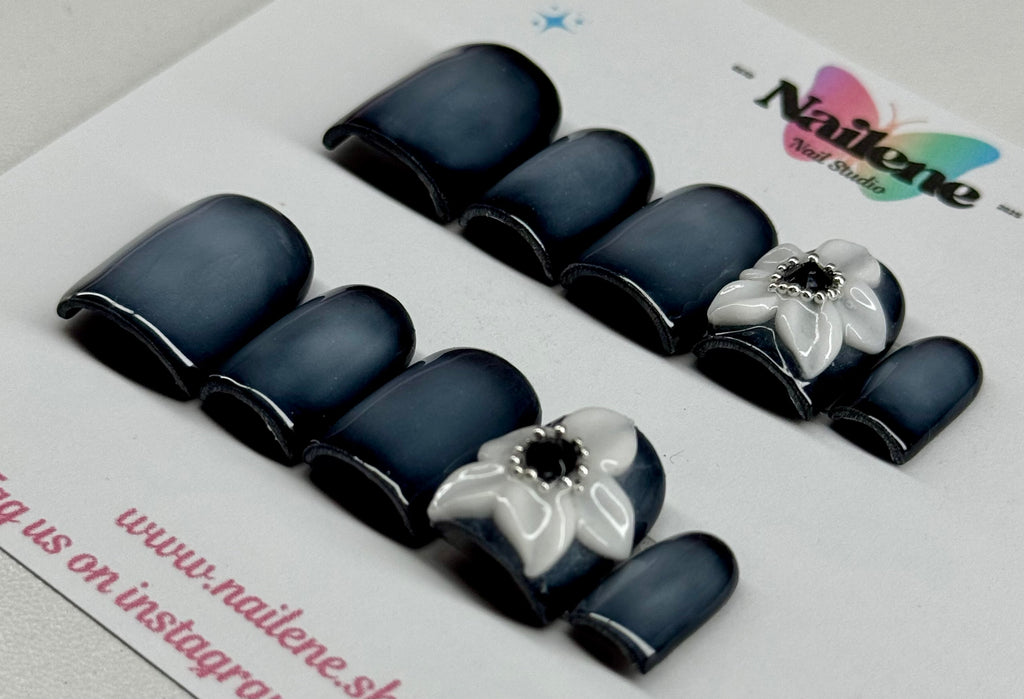 Black and white floral nail art design on a Nailene branded card.