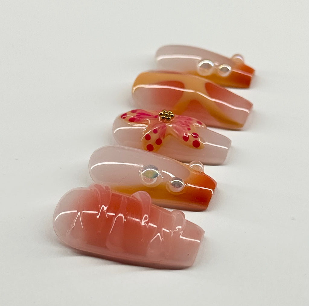 Set of decorative glass pieces with floral designs on a white background