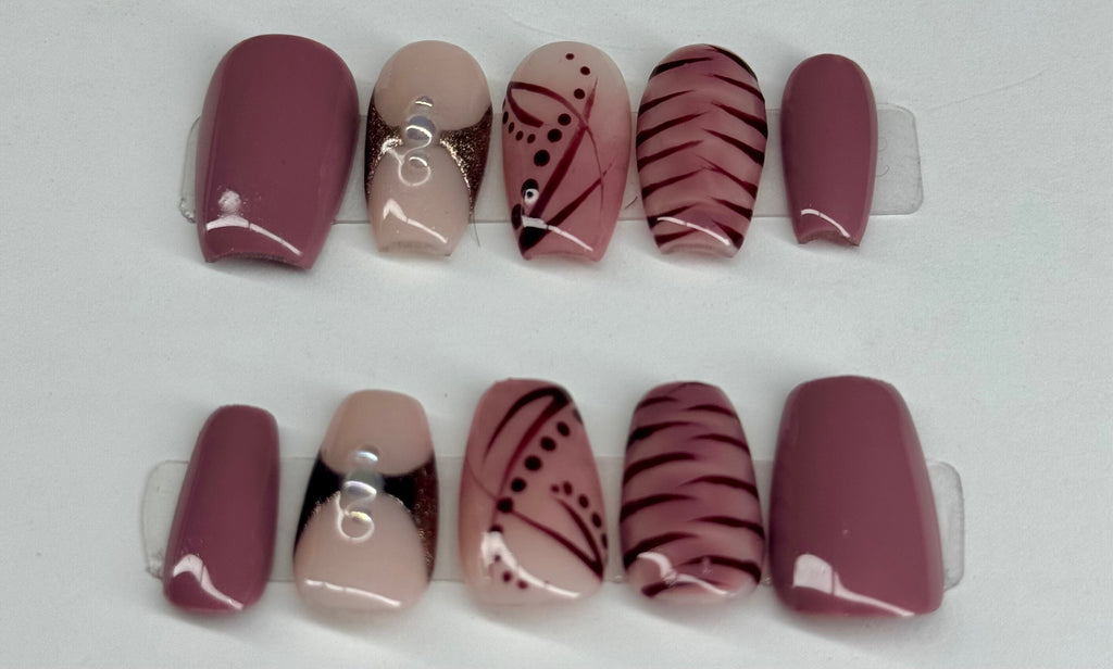 Set of nail wraps with various designs on a white background