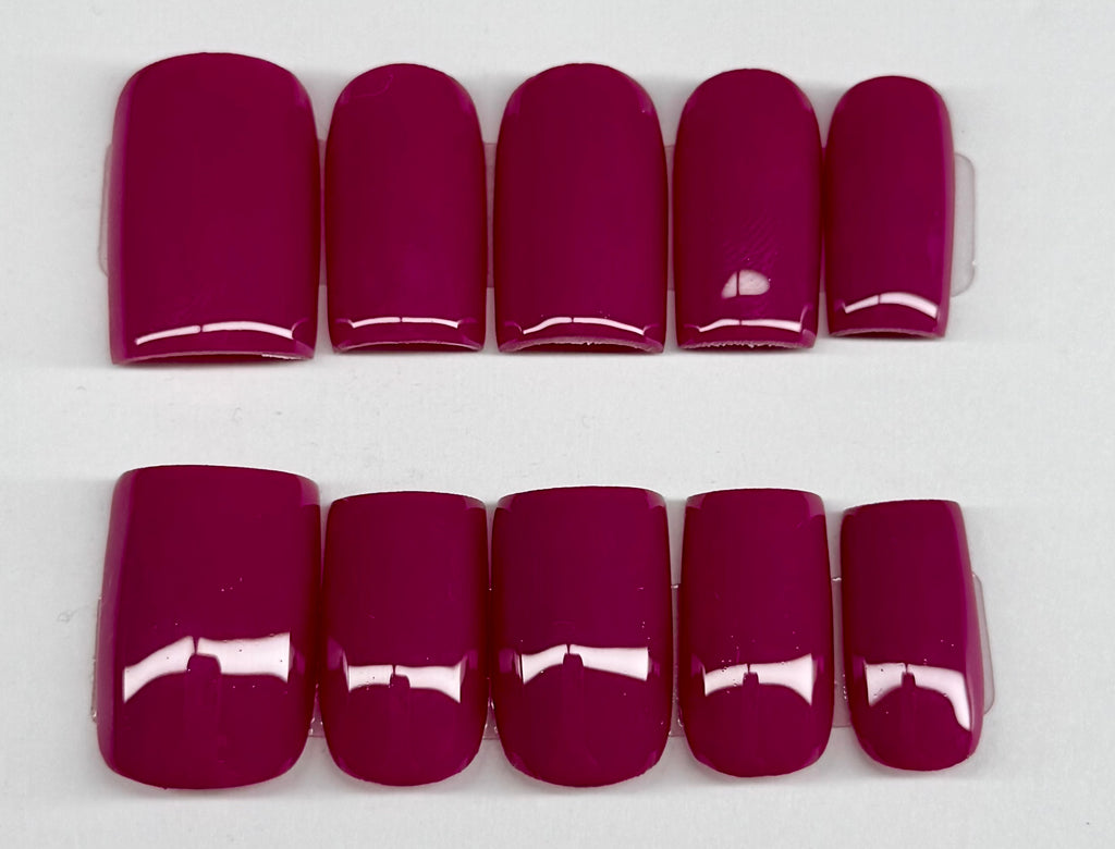Set of plum solid color nail polish on a white background