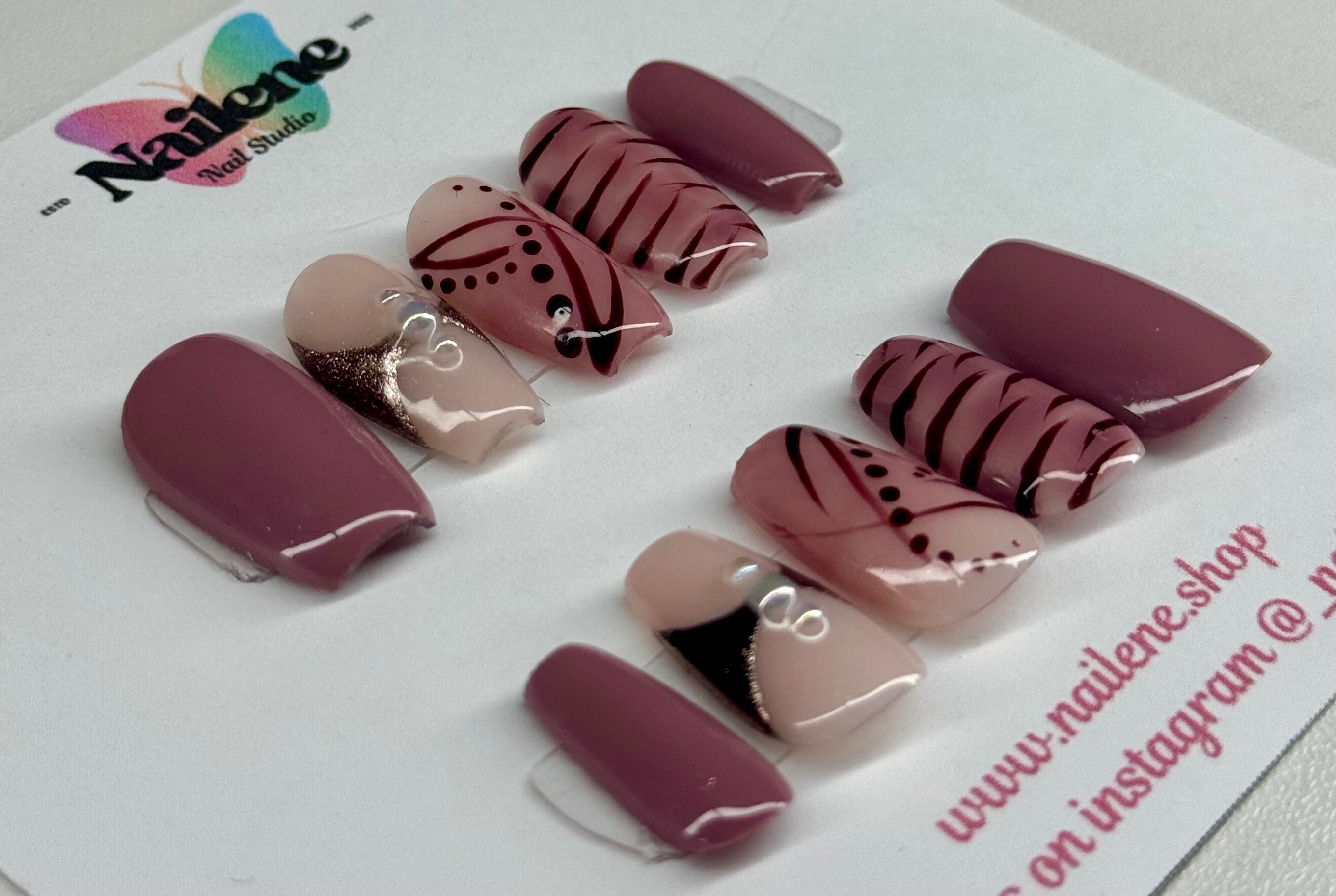 Set of maroon and beige nail designs on a white card with 'Nailene' branding.