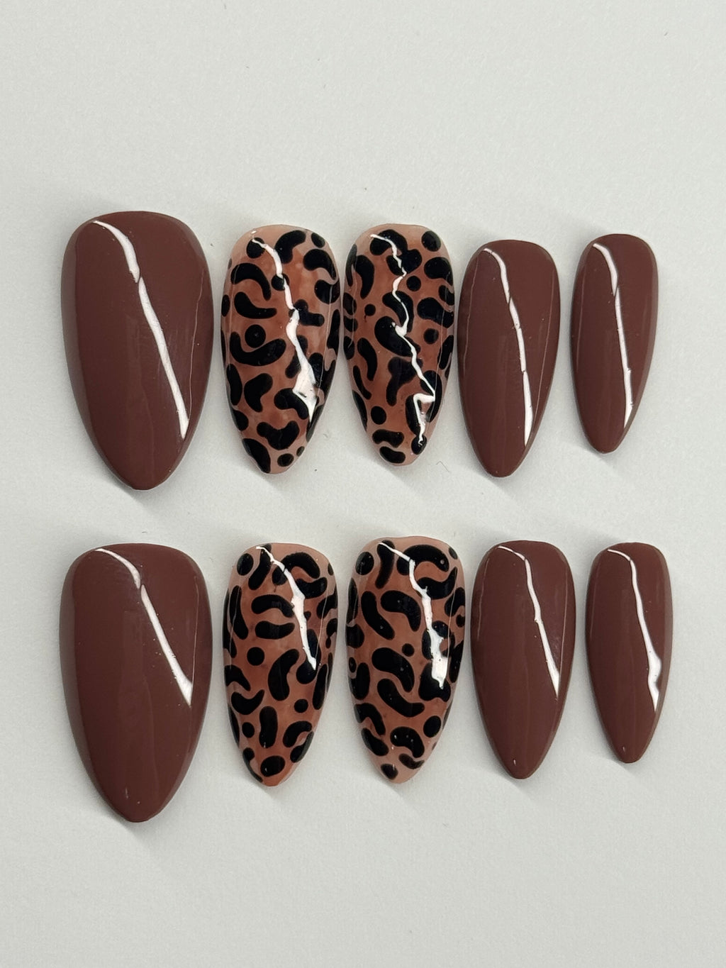 Set of decorative stones with leopard print patterns on a light gray background