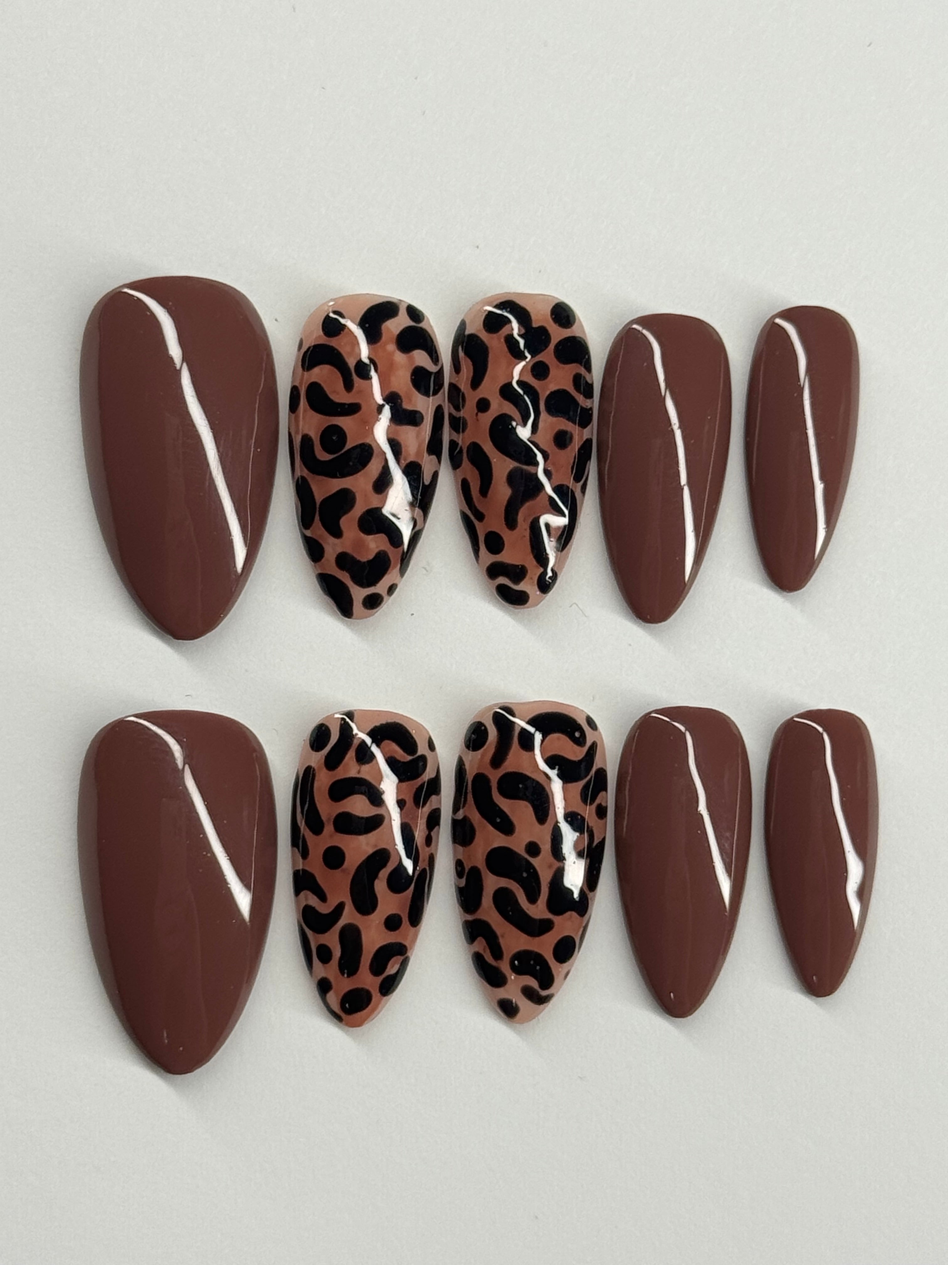 Set of decorative stones with leopard print patterns on a light gray background