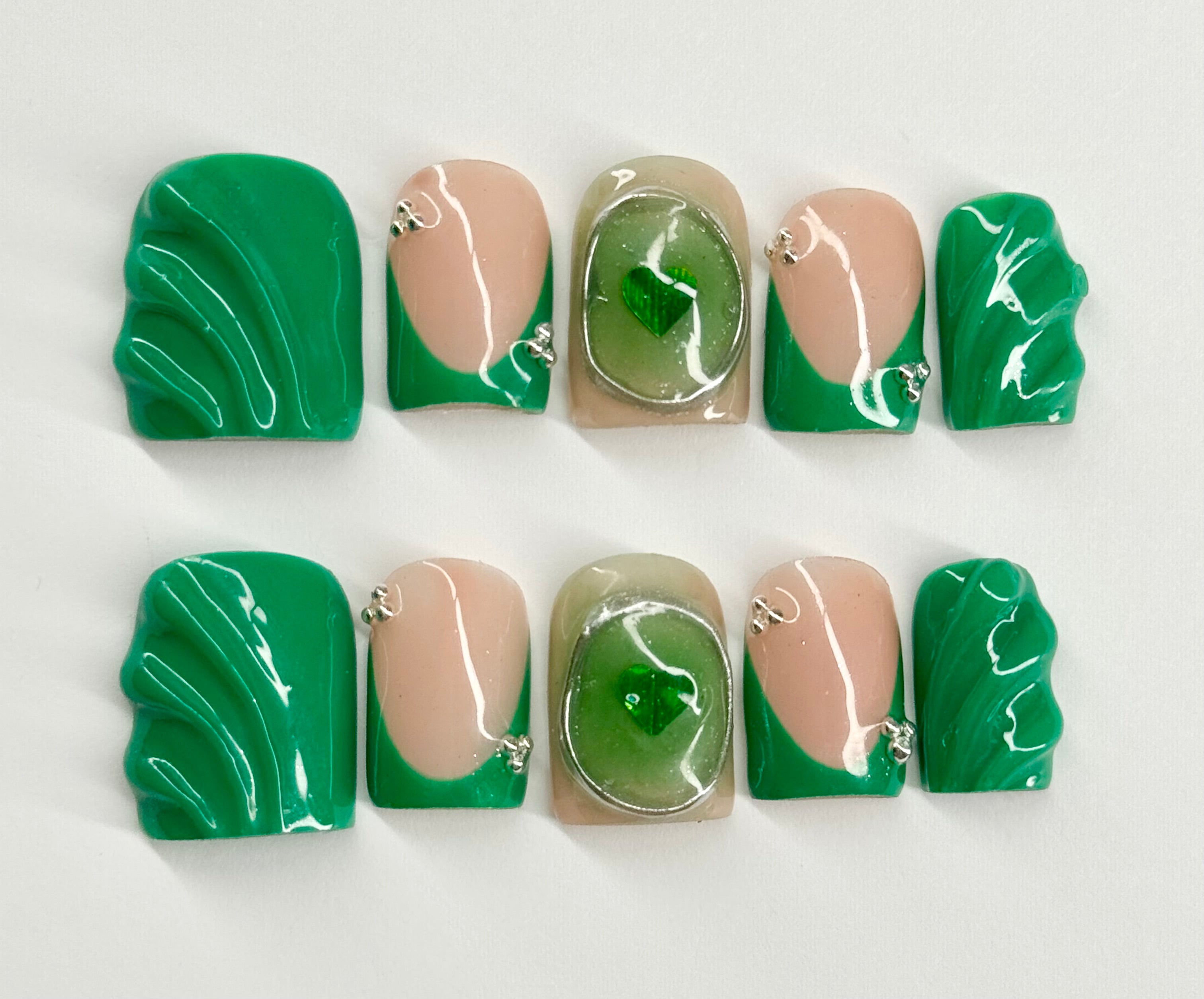 Set of green and beige marbled nail art designs on a white background